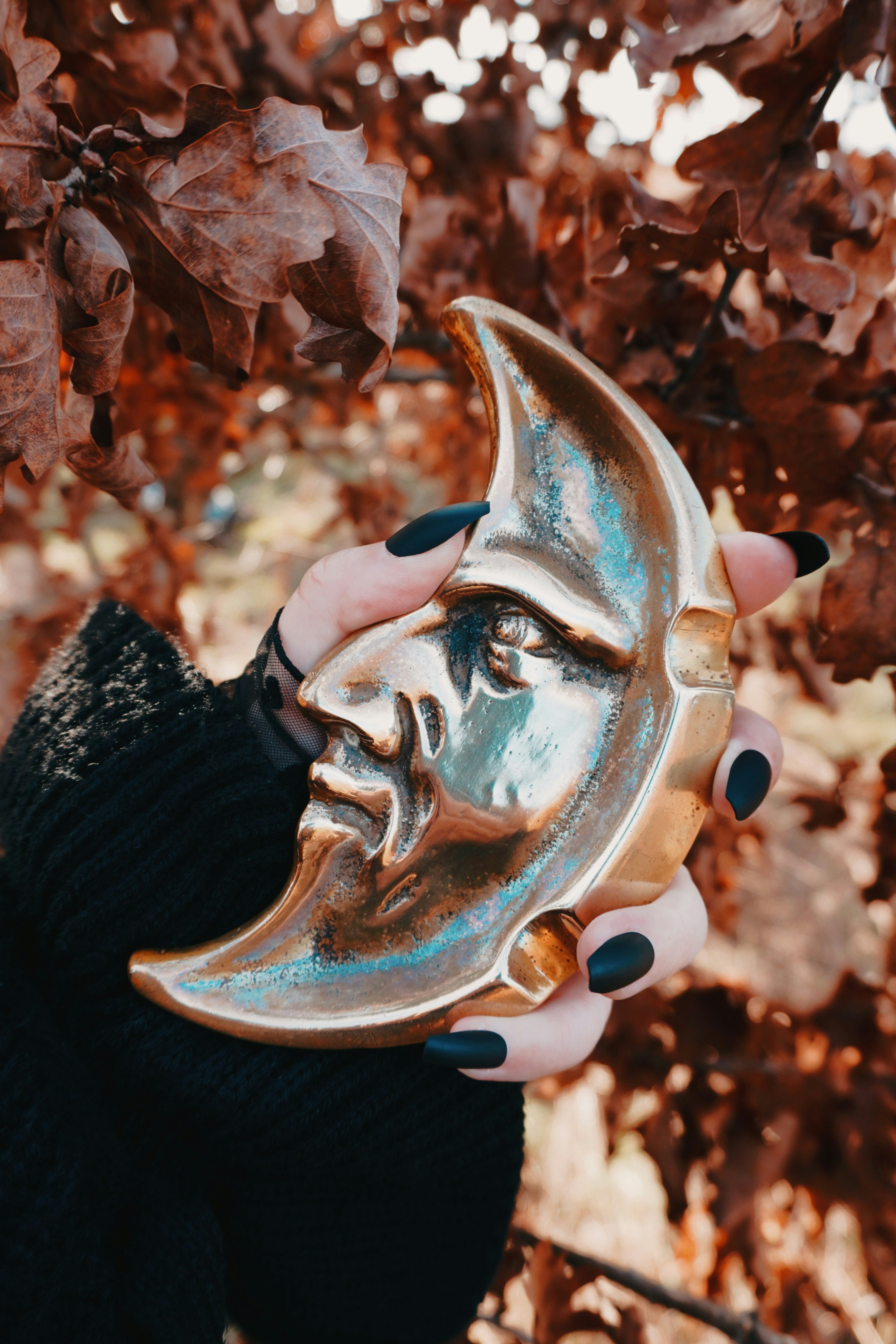 Una donna che tiene in mano una targa d'oro con una faccia su di essa