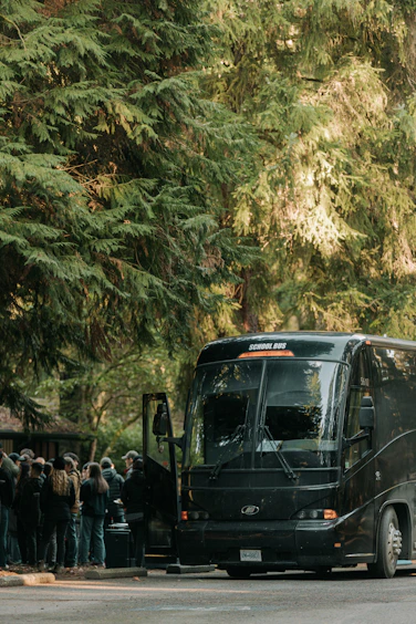 A group of people standing in front of a bus