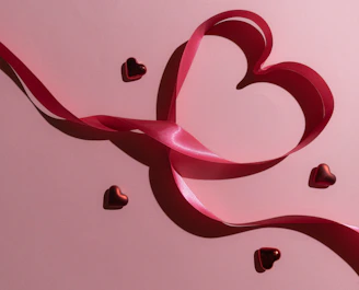 A pink background with hearts and a pink ribbon