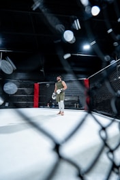 A man standing in the middle of a boxing ring