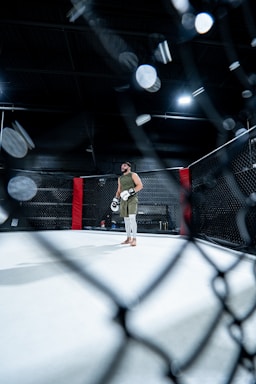 A man standing in the middle of a boxing ring