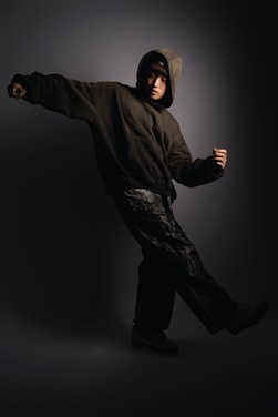 A man in a black hoodie is dancing