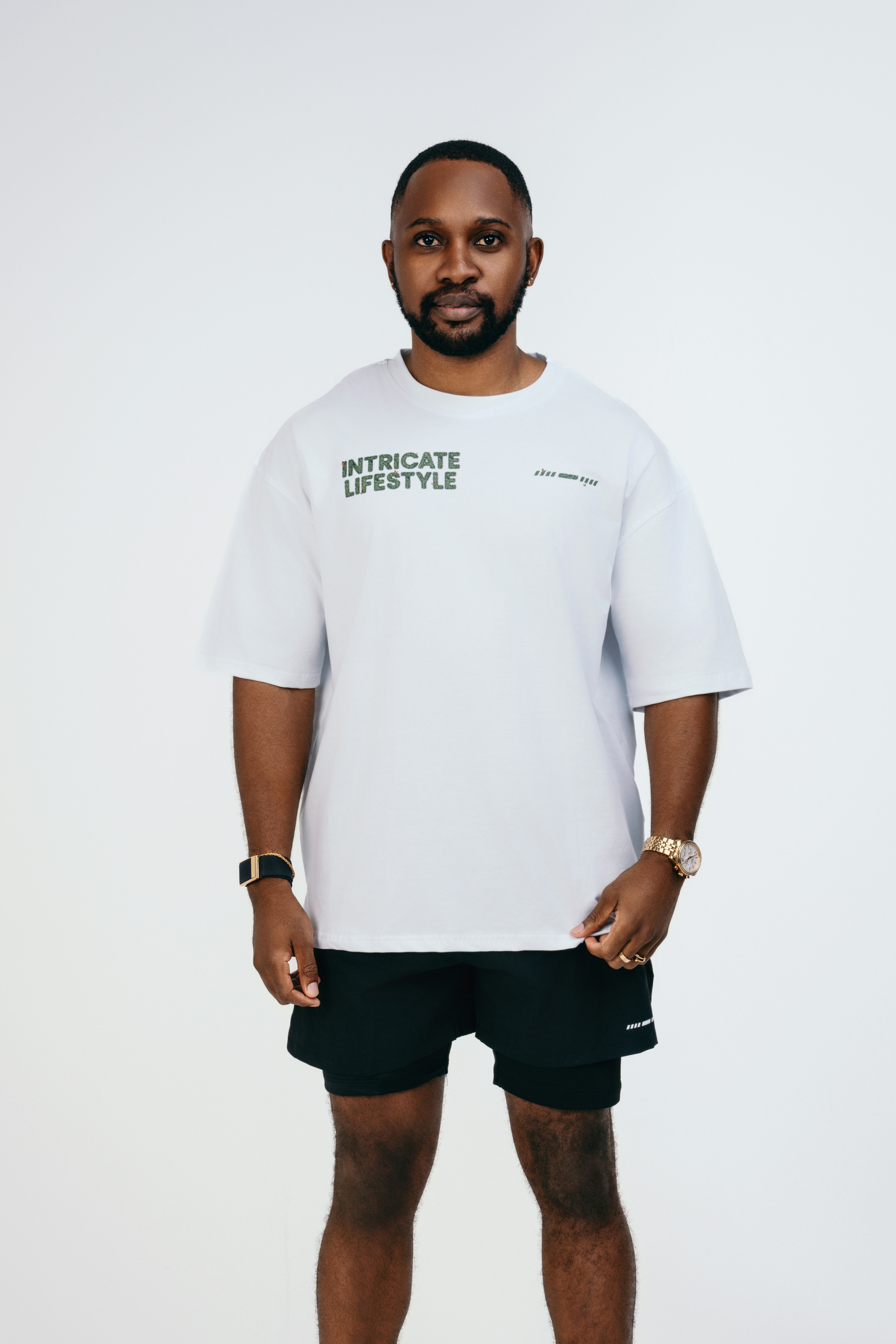 A man in a white shirt and black shorts