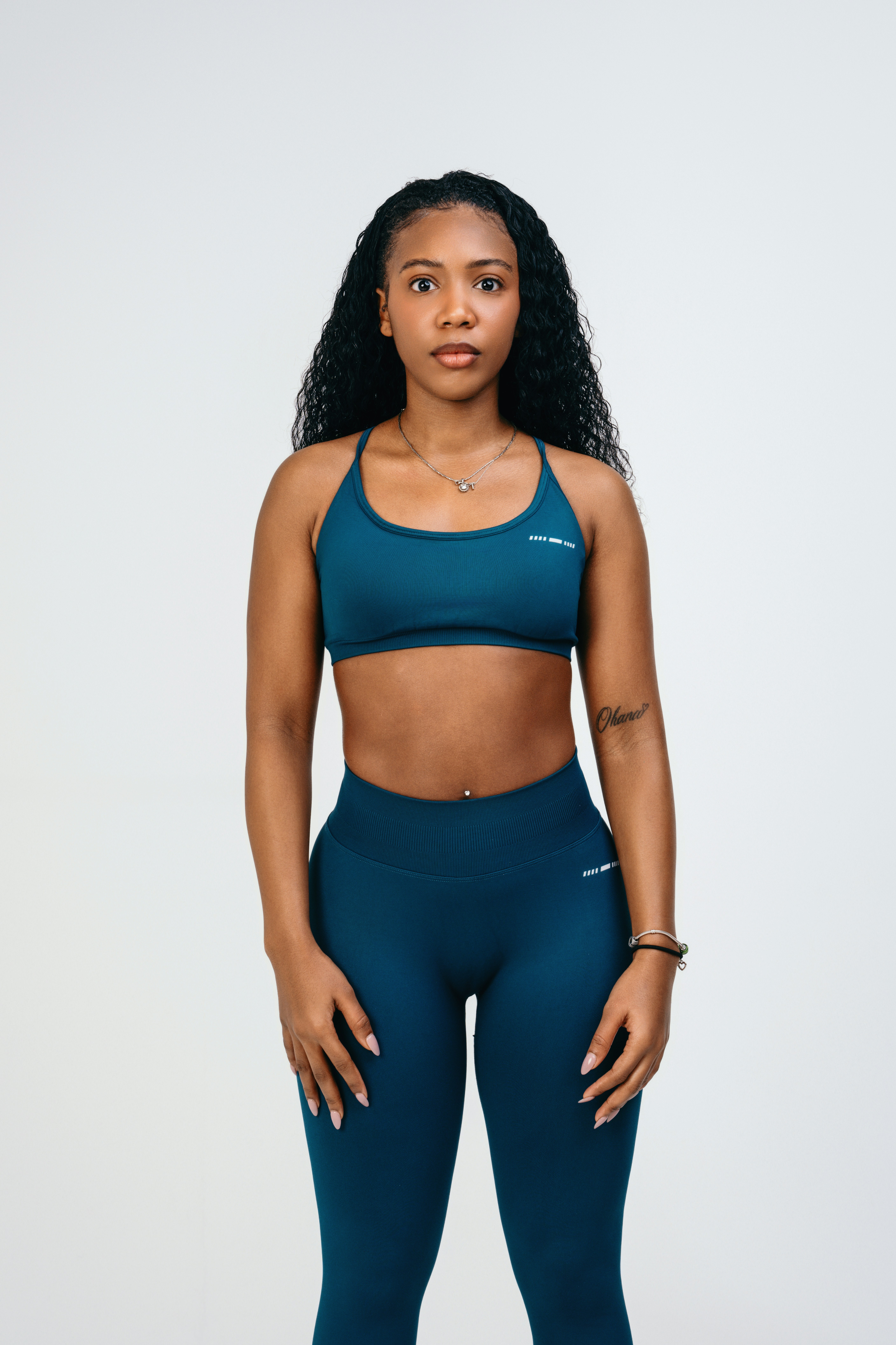 A woman in a blue sports bra top and leggings