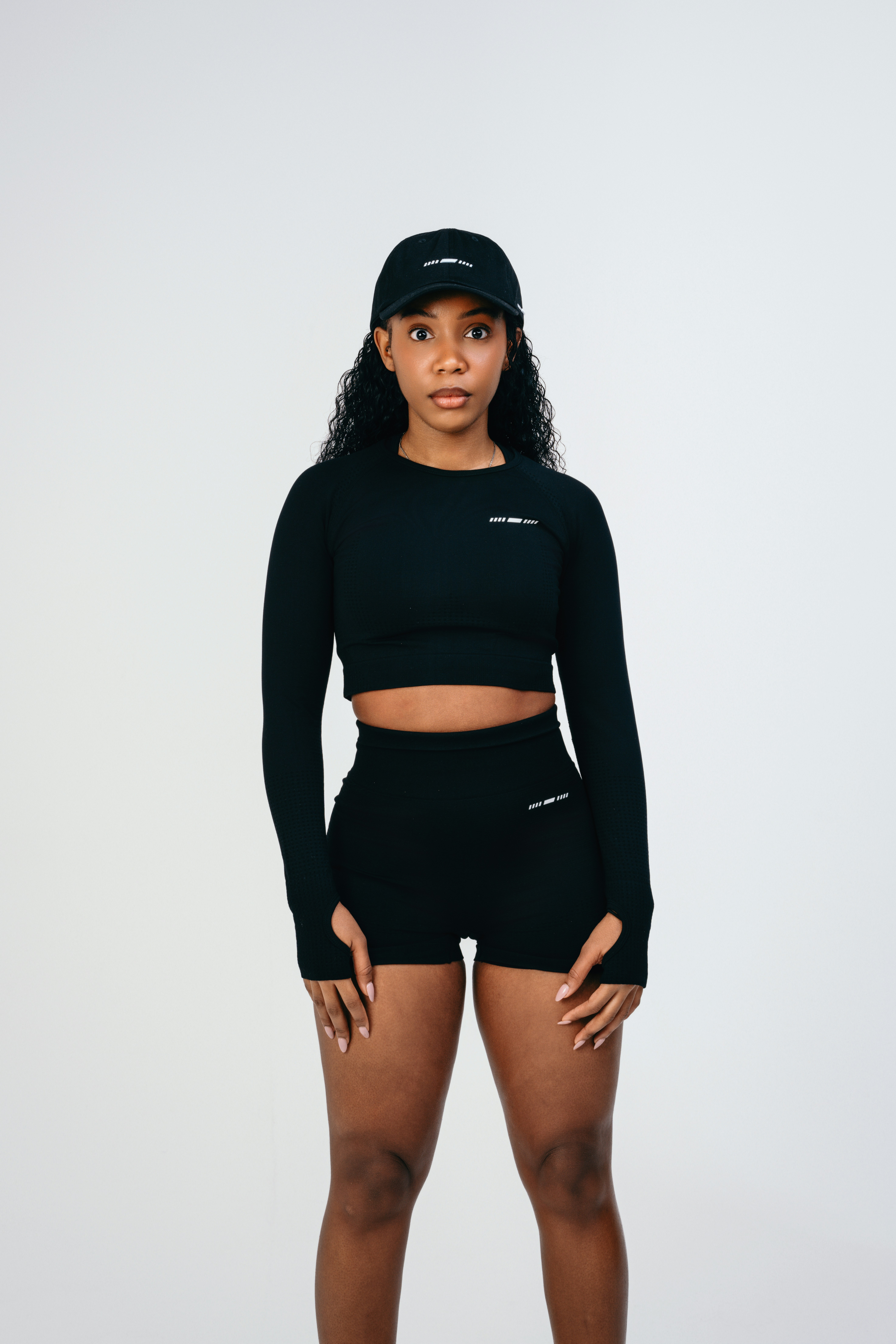 A woman in a black top and shorts