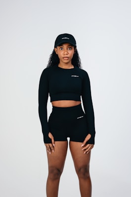 A woman in a black top and shorts