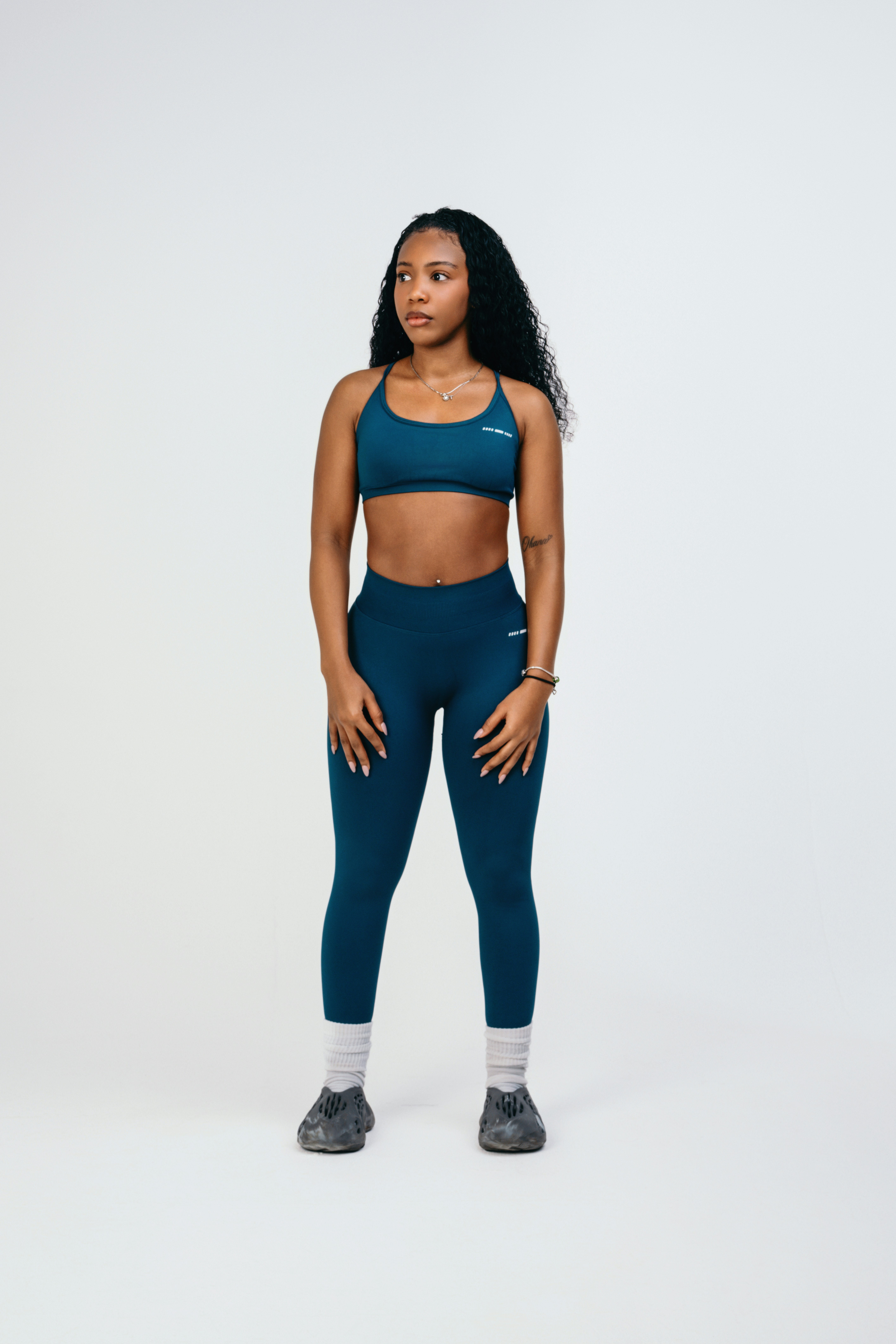 A woman in a blue sports bra top and leggings