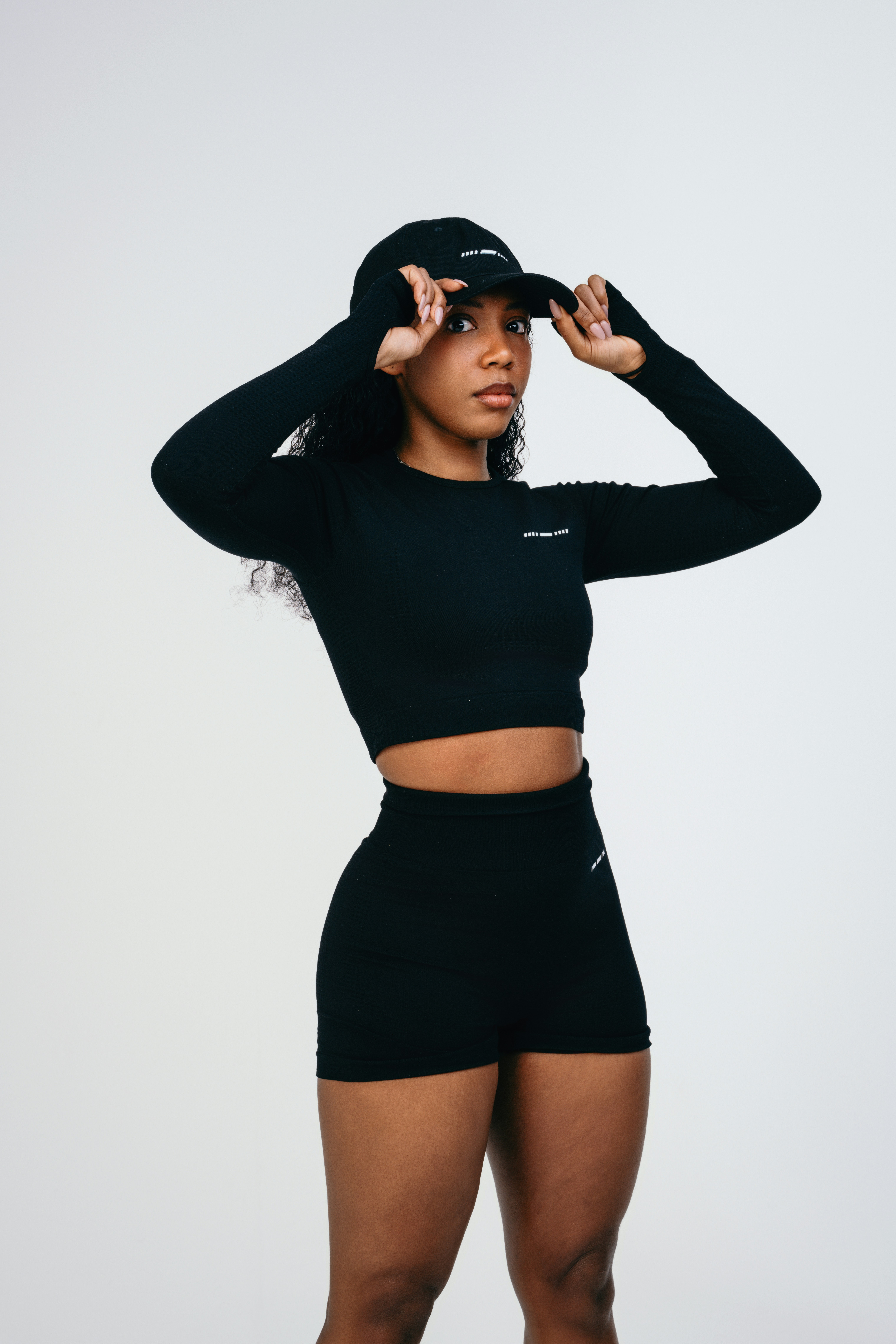 A woman in a black top and shorts