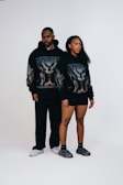 A man and a woman standing in front of a white background