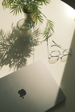 A laptop computer sitting on top of a white table