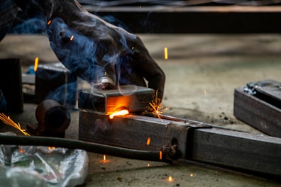 A man is welding a piece of metal