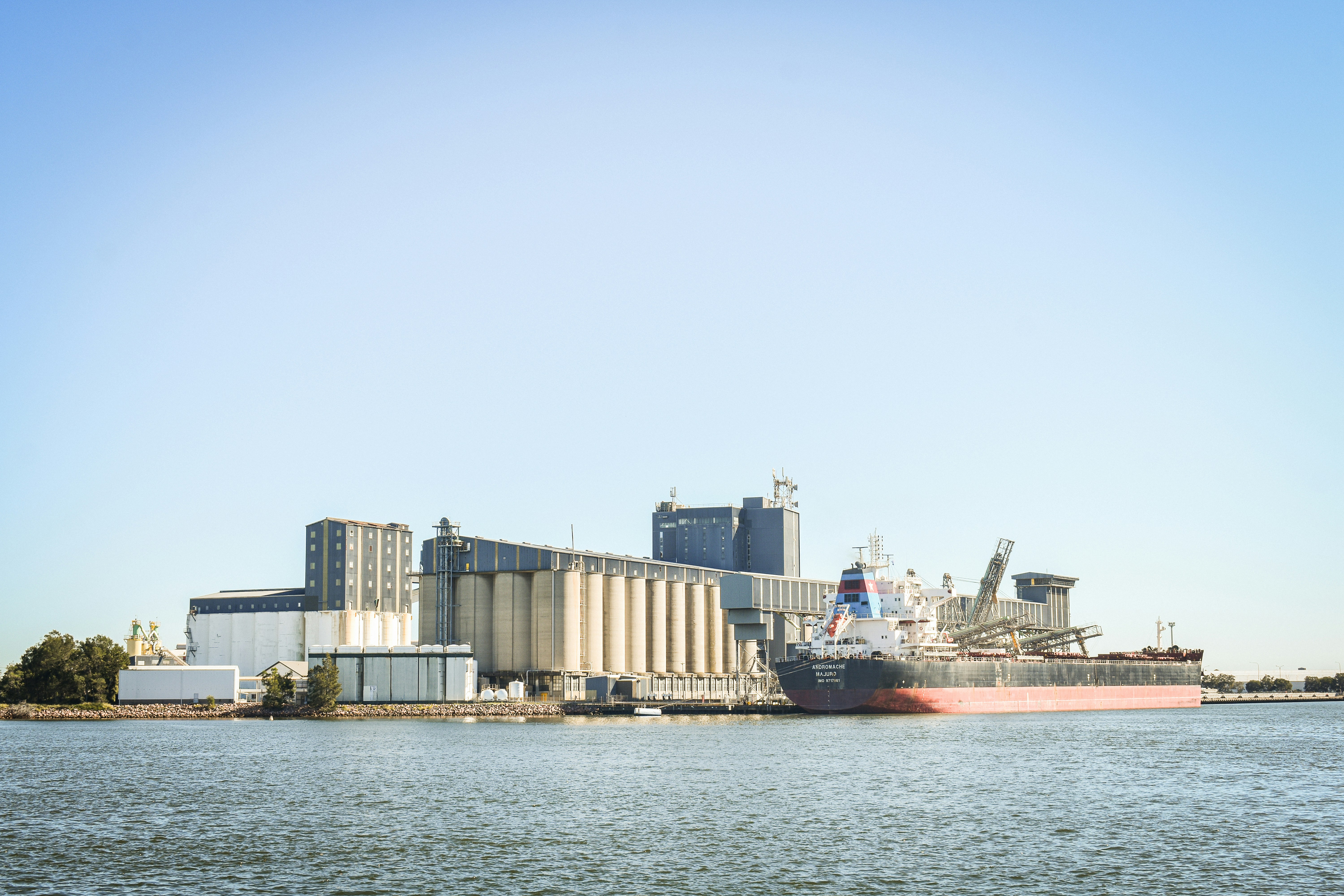 A large ship is docked in a harbor