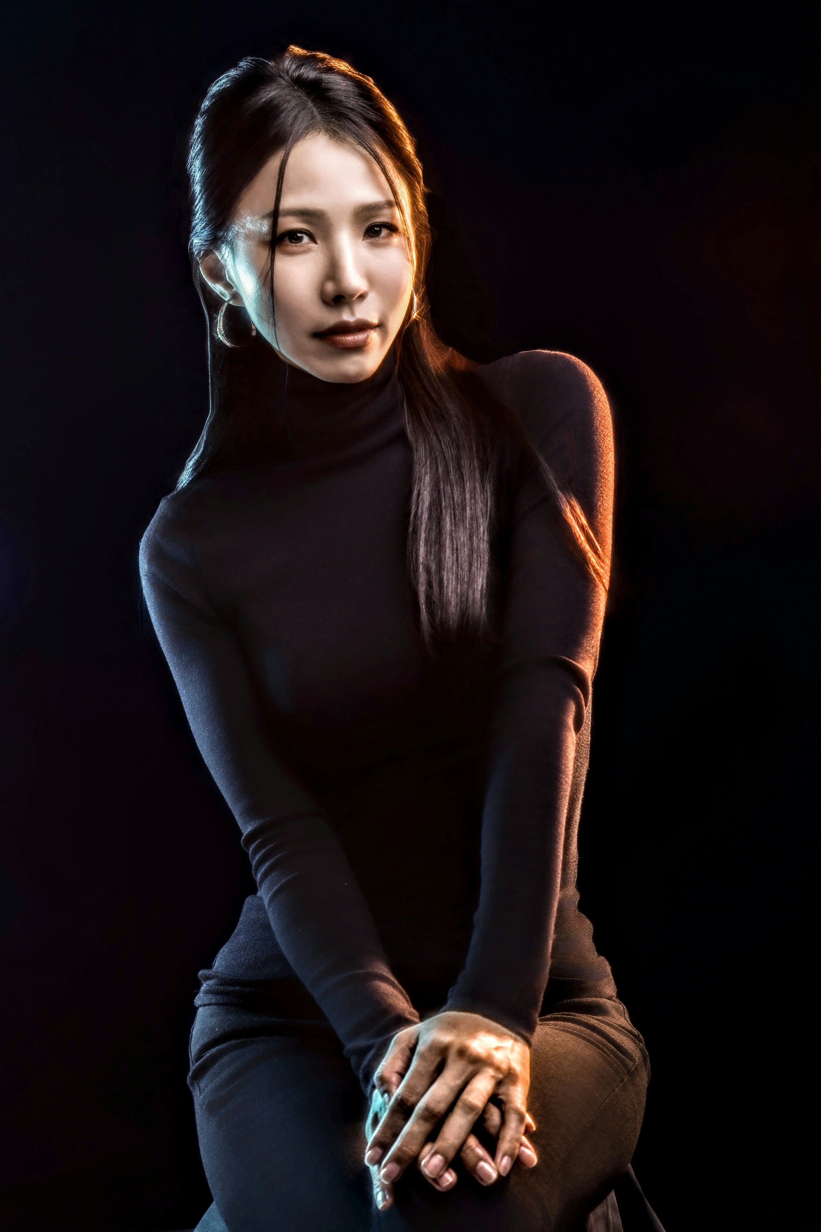 A woman sitting on top of a stool