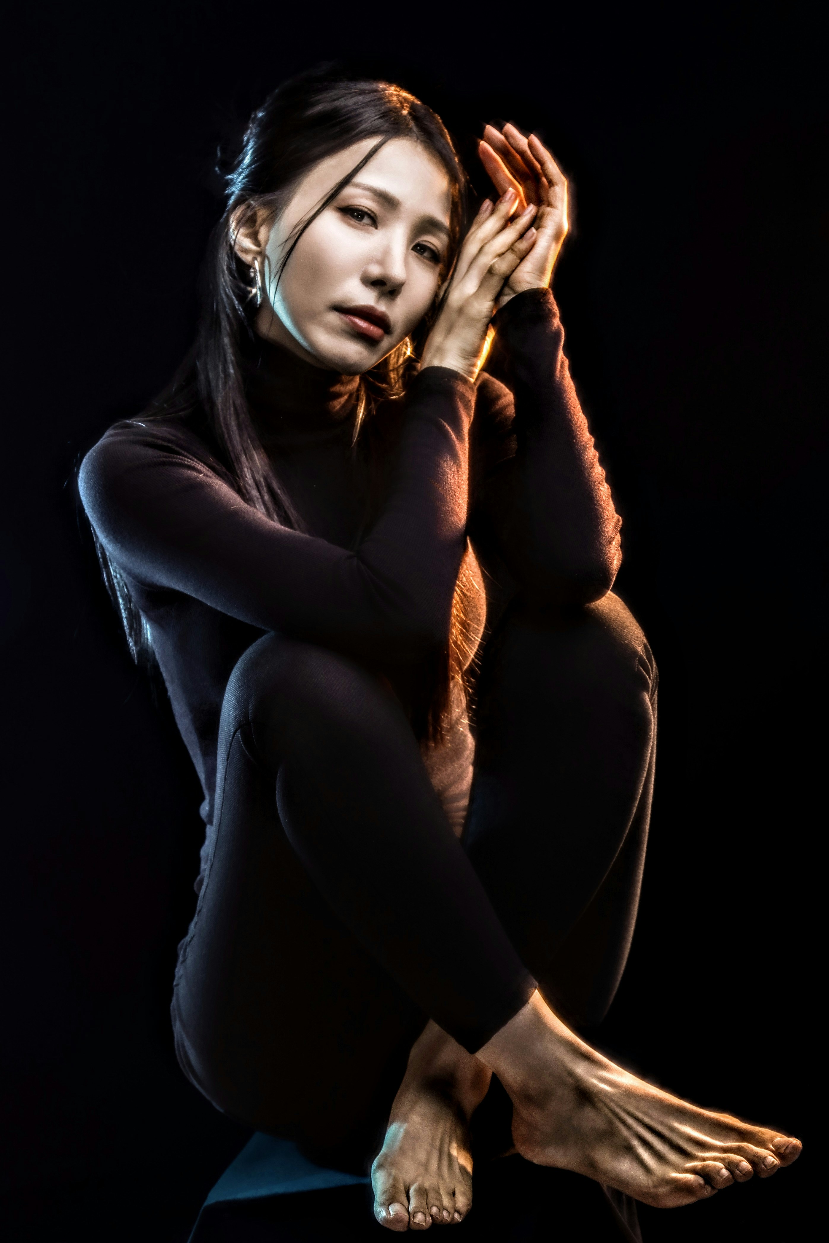 A woman sitting on the ground with her legs crossed