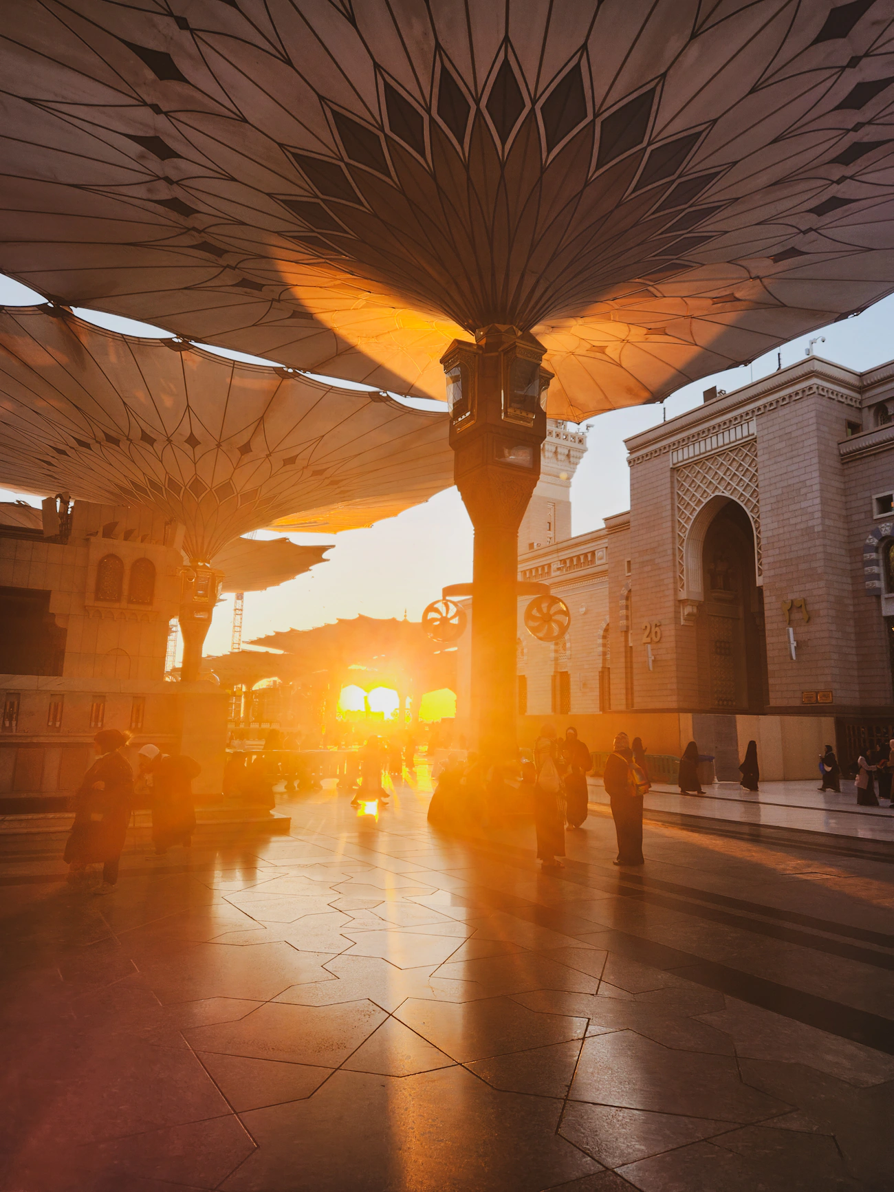 Pilgrims approaching Masjid an-Nabawi in Madinah at sunset