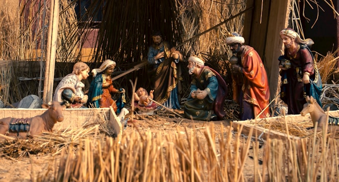 A group of people standing around a nativity scene