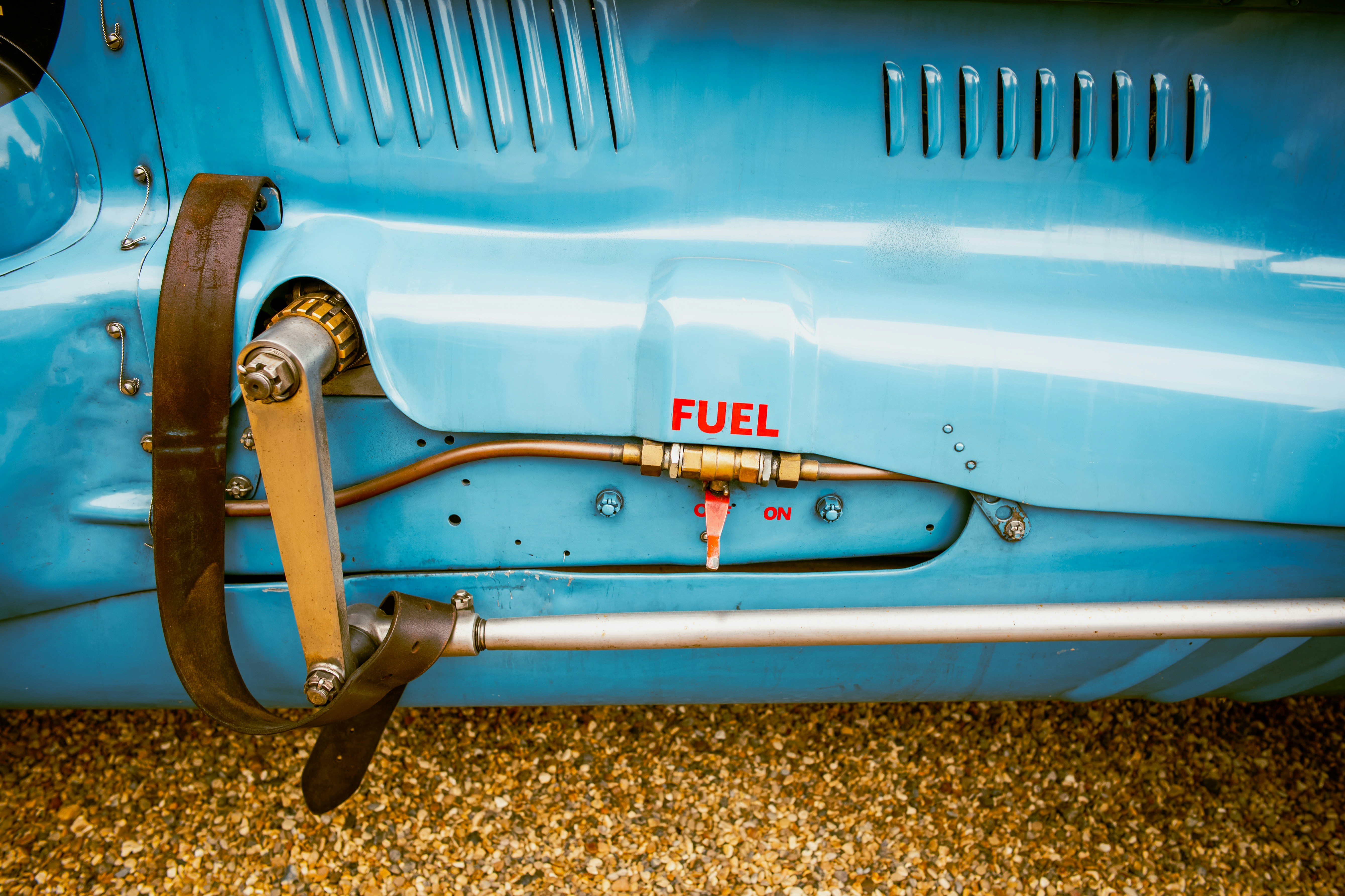 A close up of the front end of a blue car