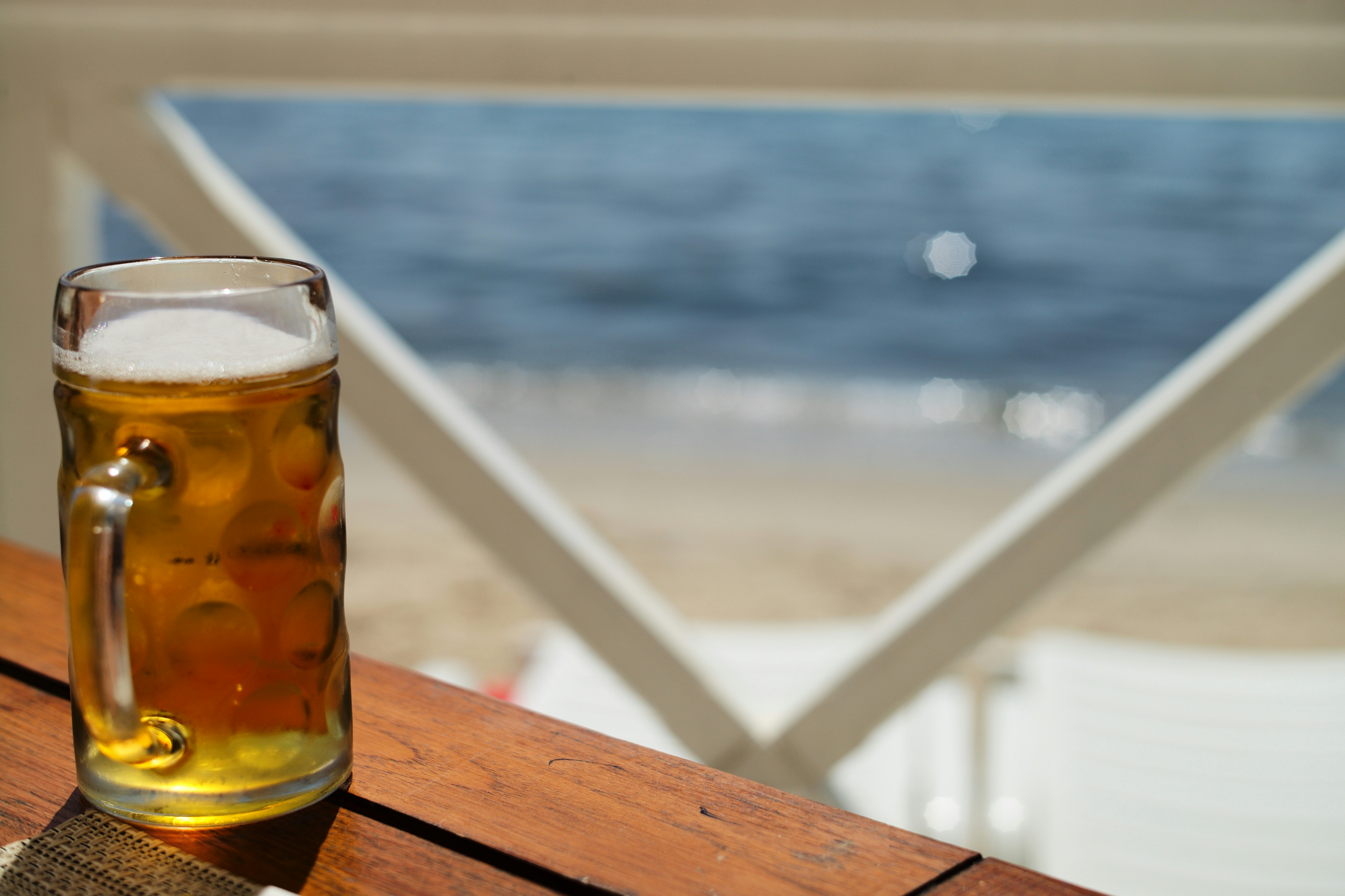 A glass of beer sitting on top of a wooden table photo – Free Beer ...