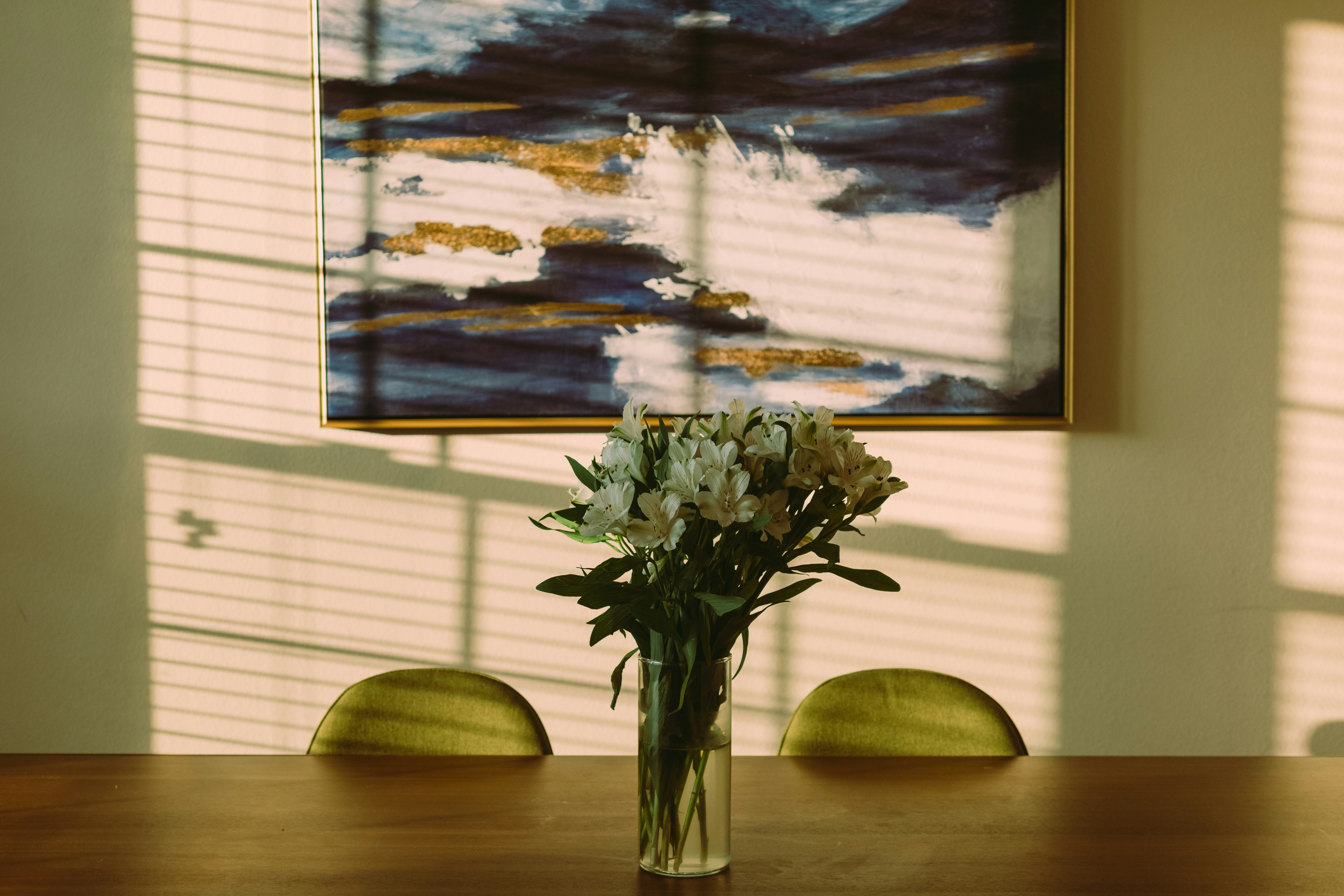 A vase filled with flowers sitting on top of a wooden table