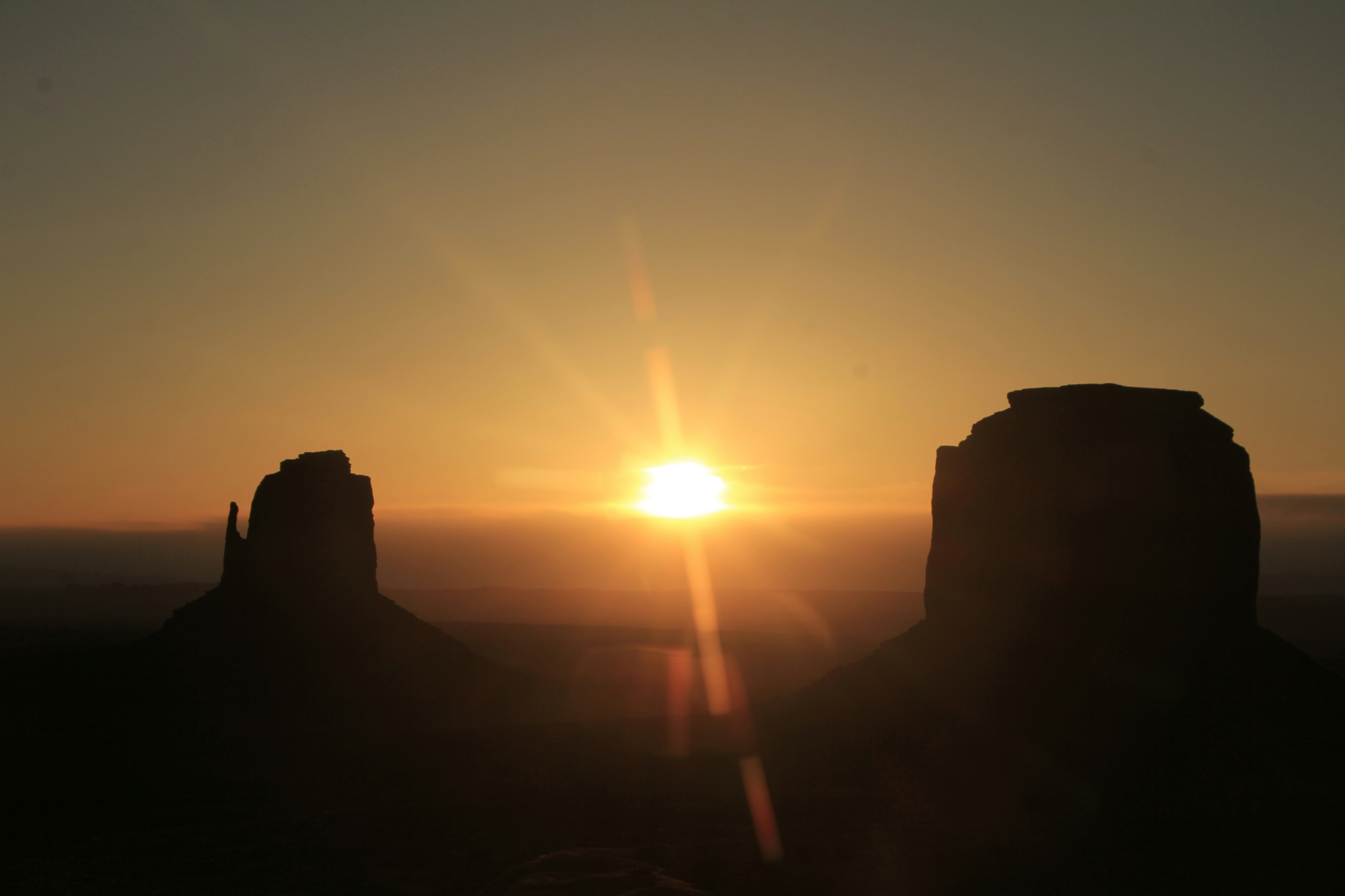 The sun is setting over a mountain range