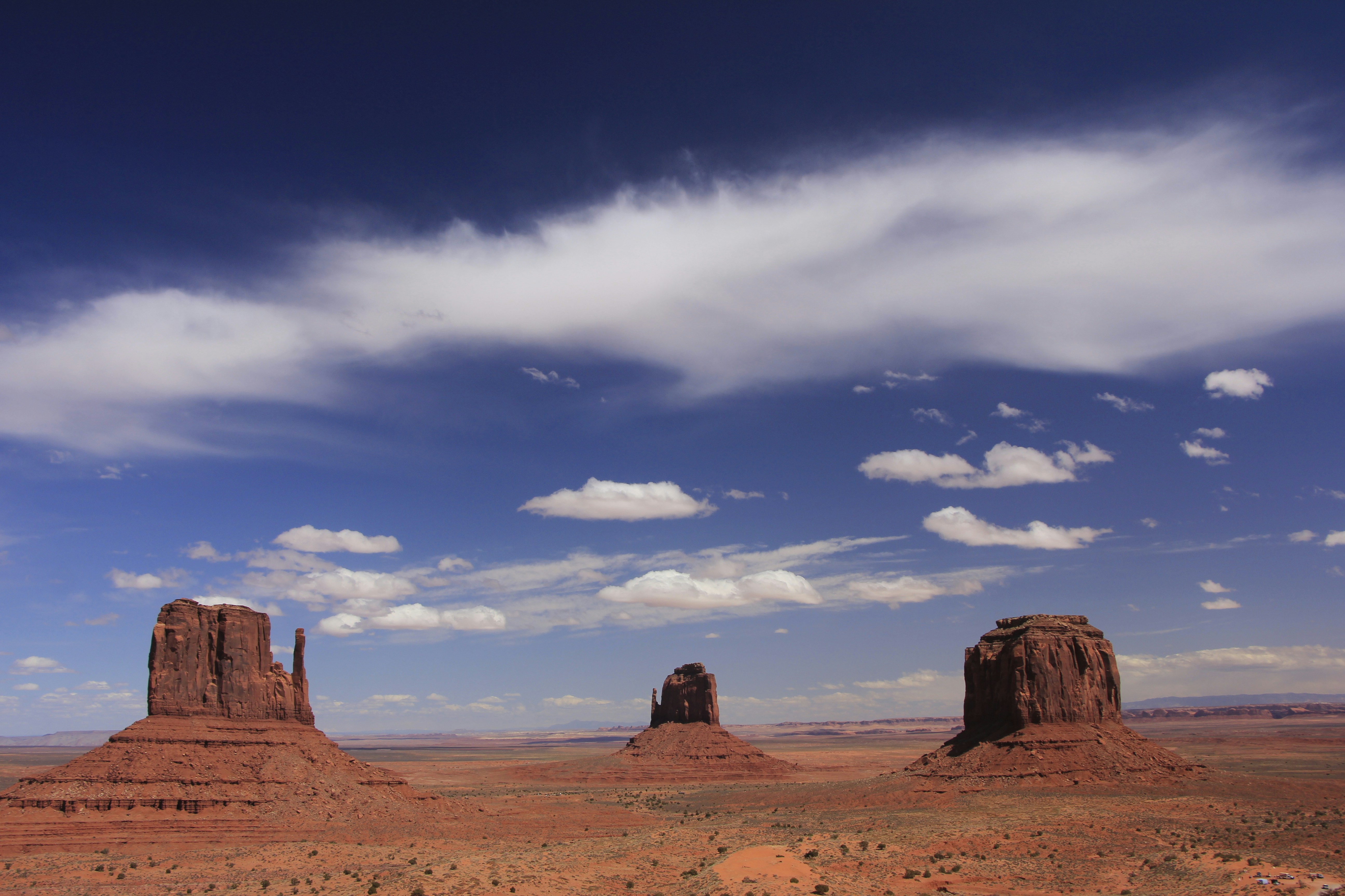 A desert landscape with rocks and clouds in the sky