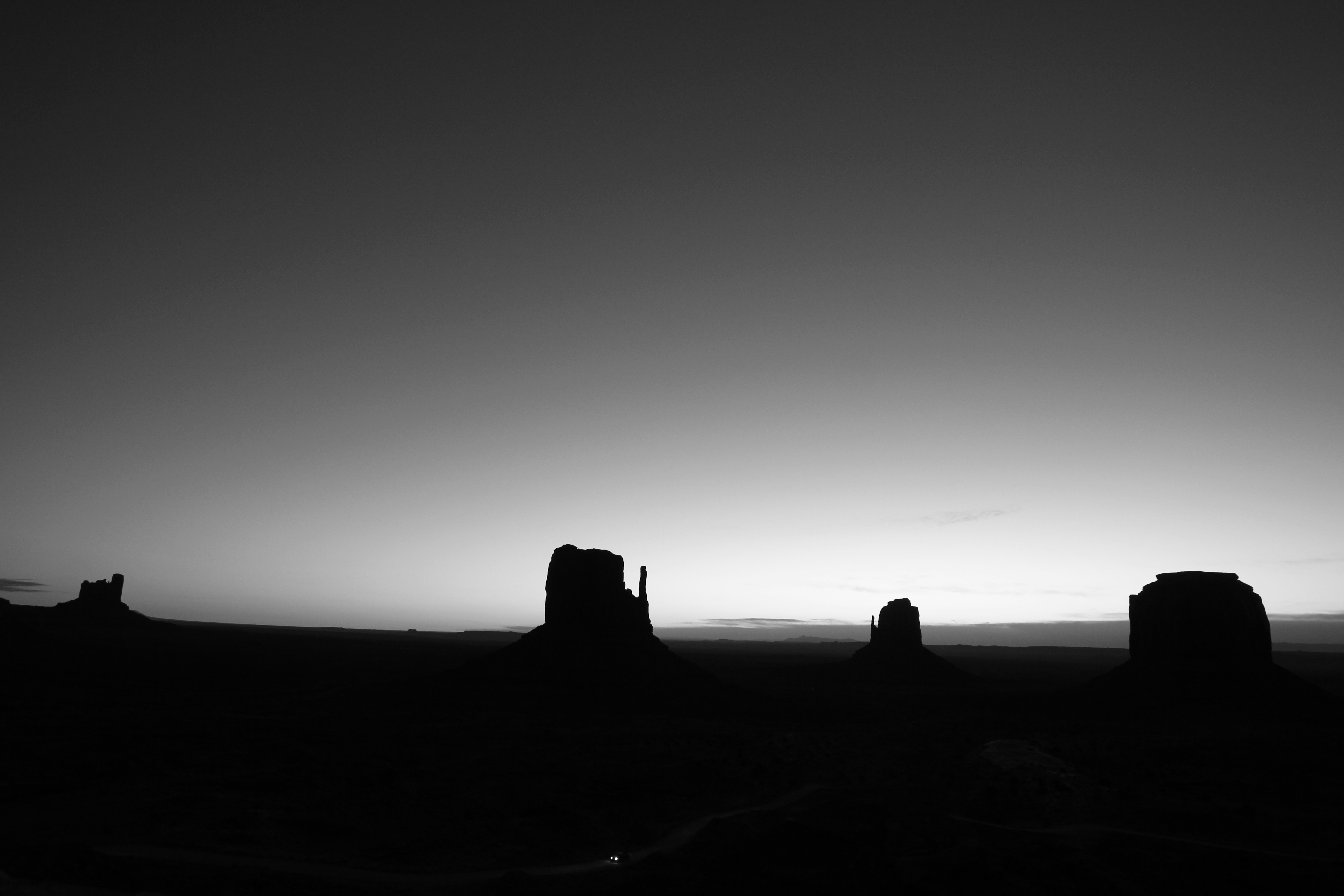A black and white photo of the setting sun