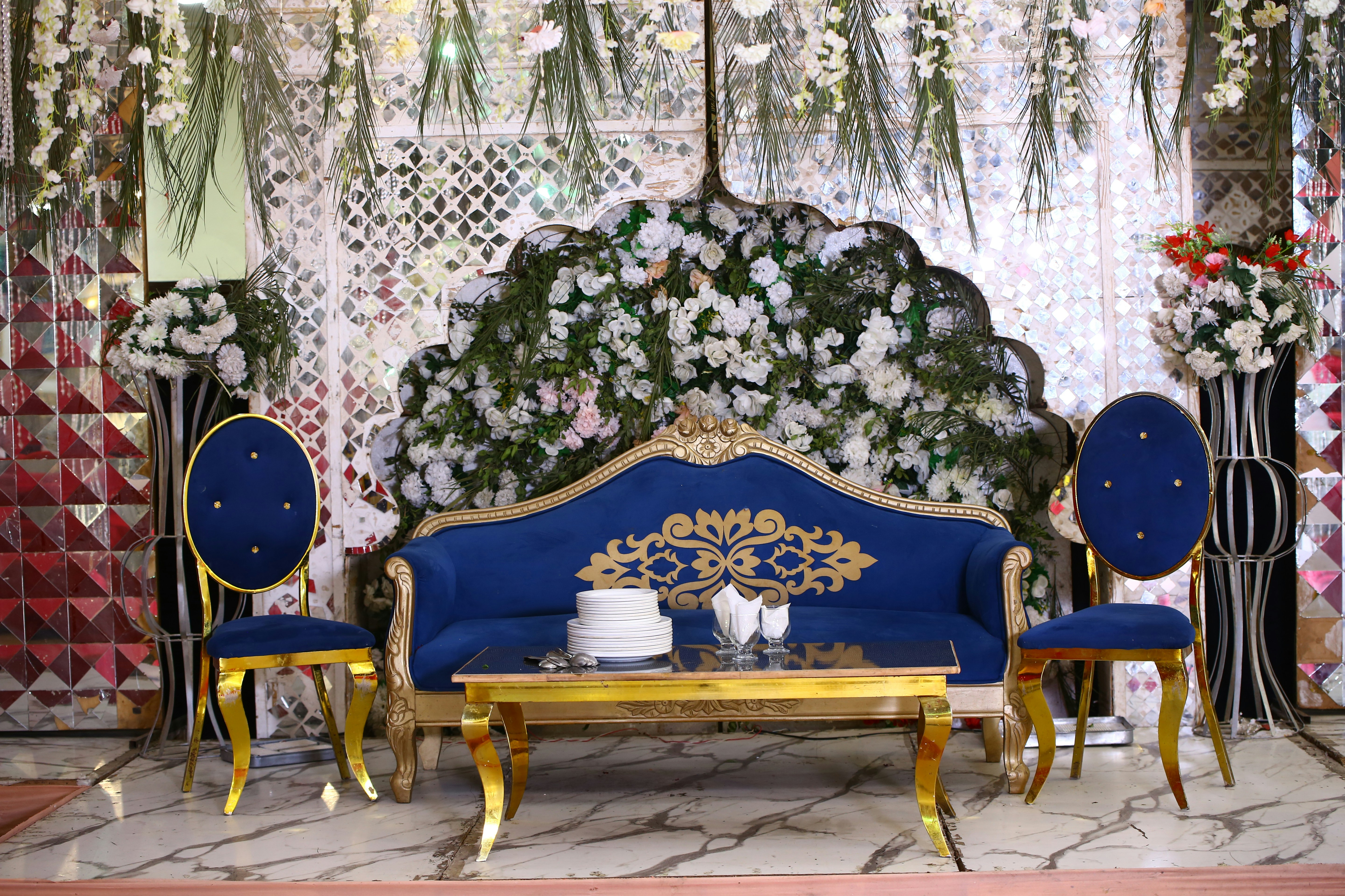 A living room with a blue couch and chairs