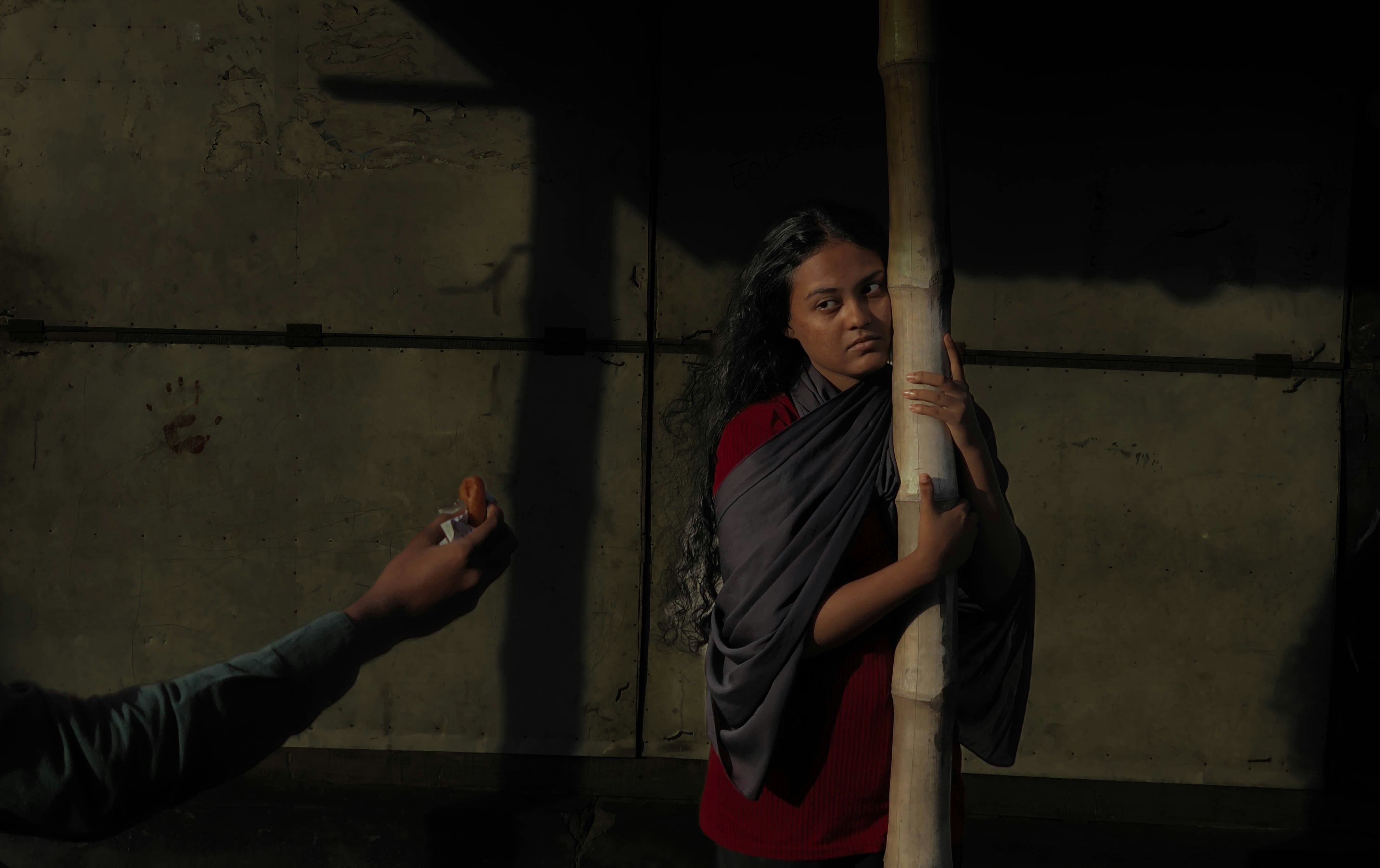 A man holding a bat next to a woman