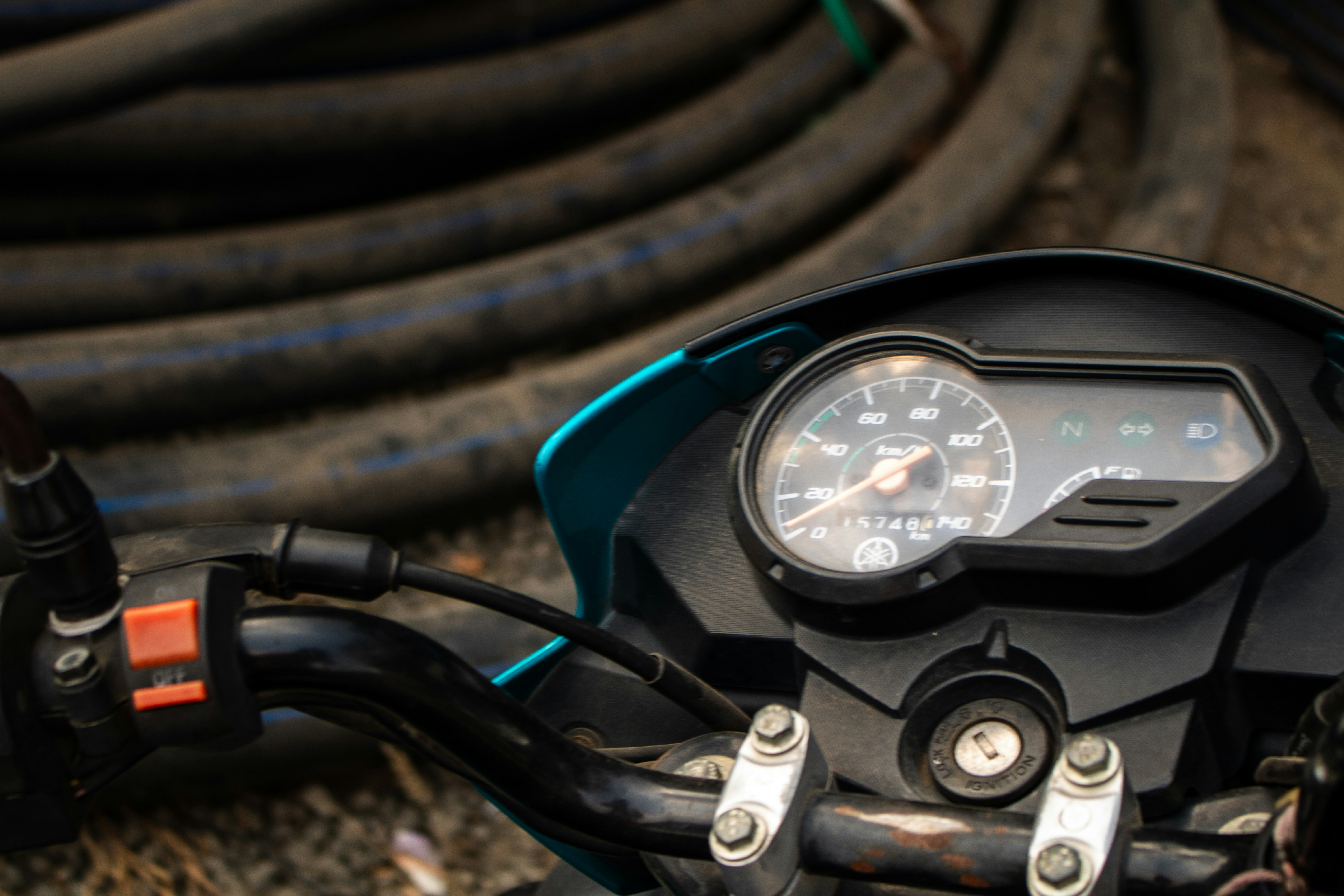 A close up of a motorcycle handlebar and gauge