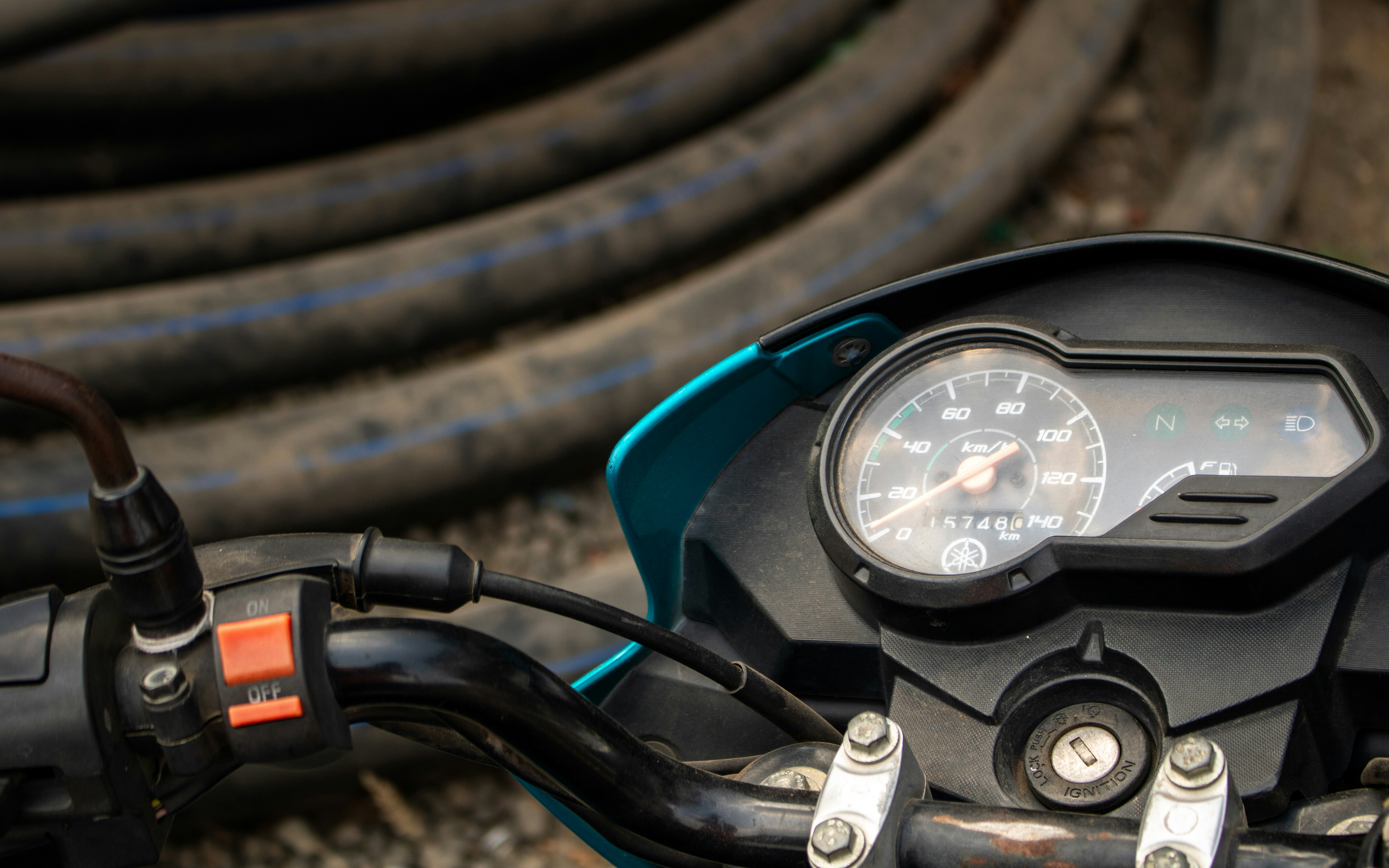 A close up of a motorcycle handlebar and gauge