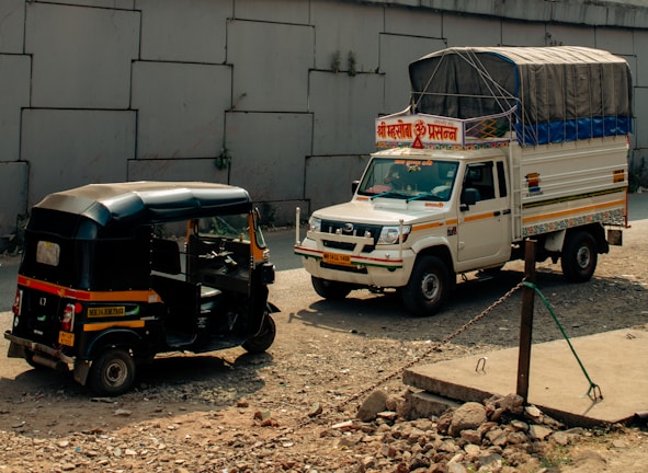 Two vehicles parked next to each other near a building
