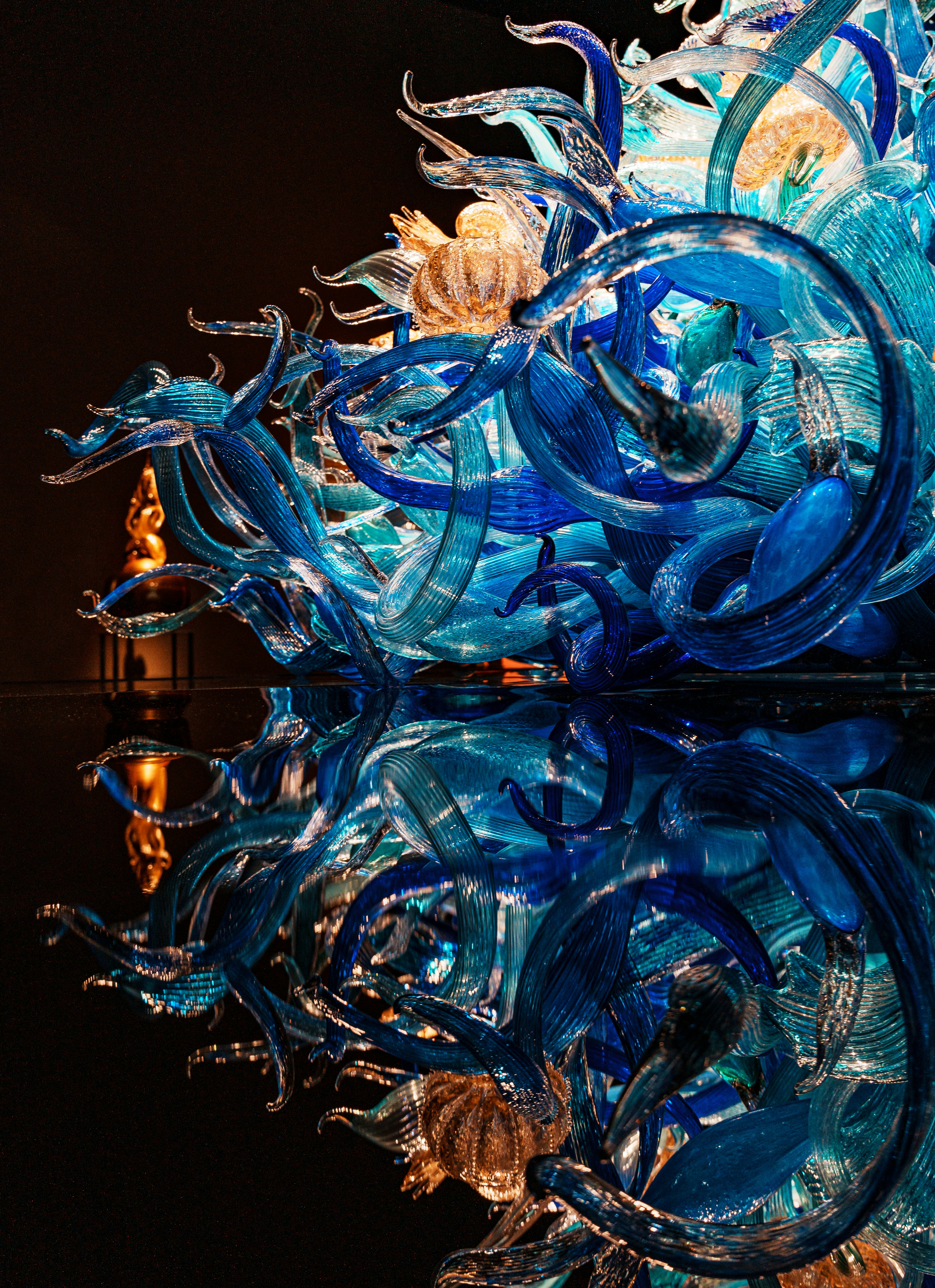 A blue glass sculpture sitting on top of a table photo – Free Woman ...