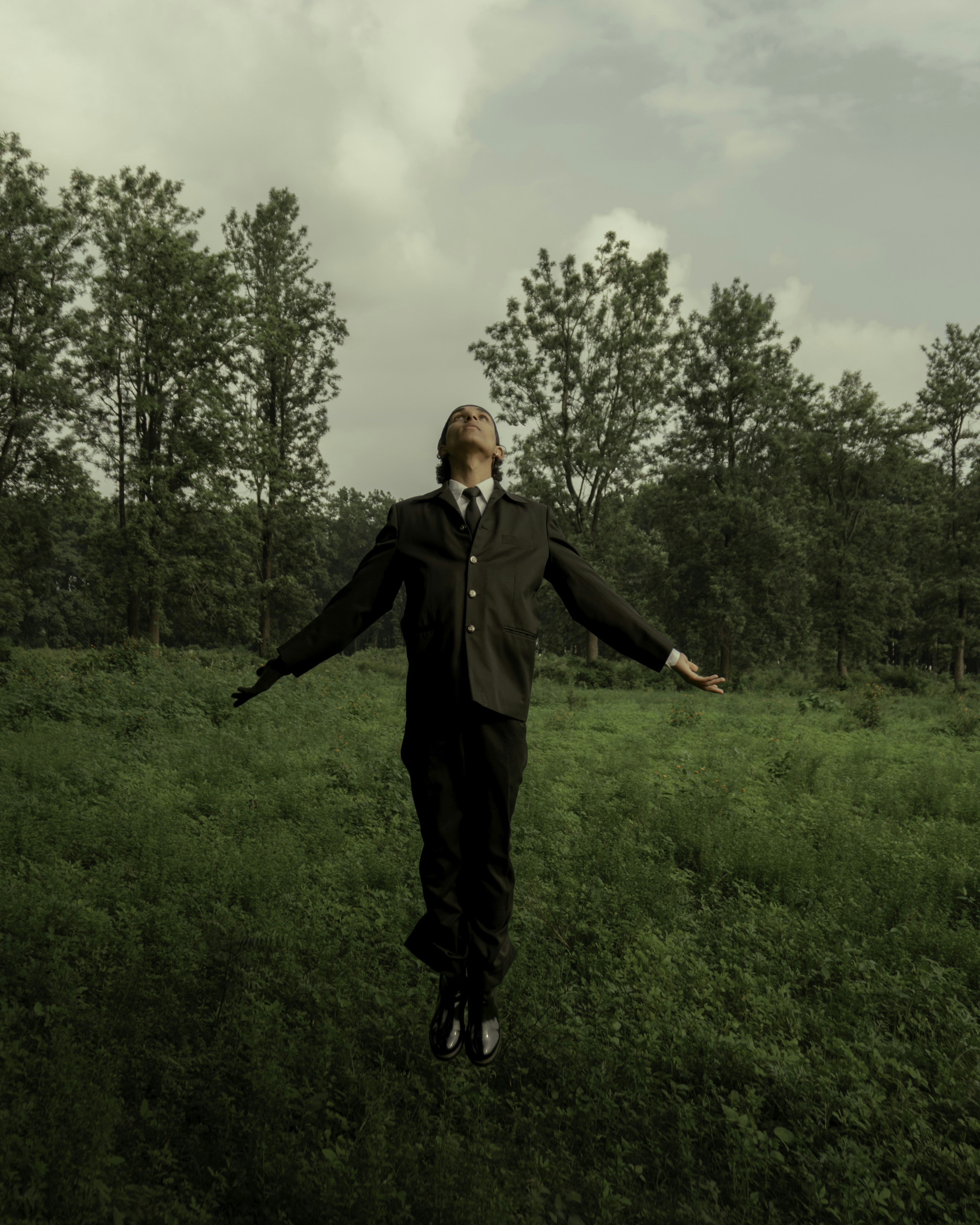 Green Background, levitating man under the smoky clouds. Enjoy the nature. Beautiful scene from Uttarakhand.