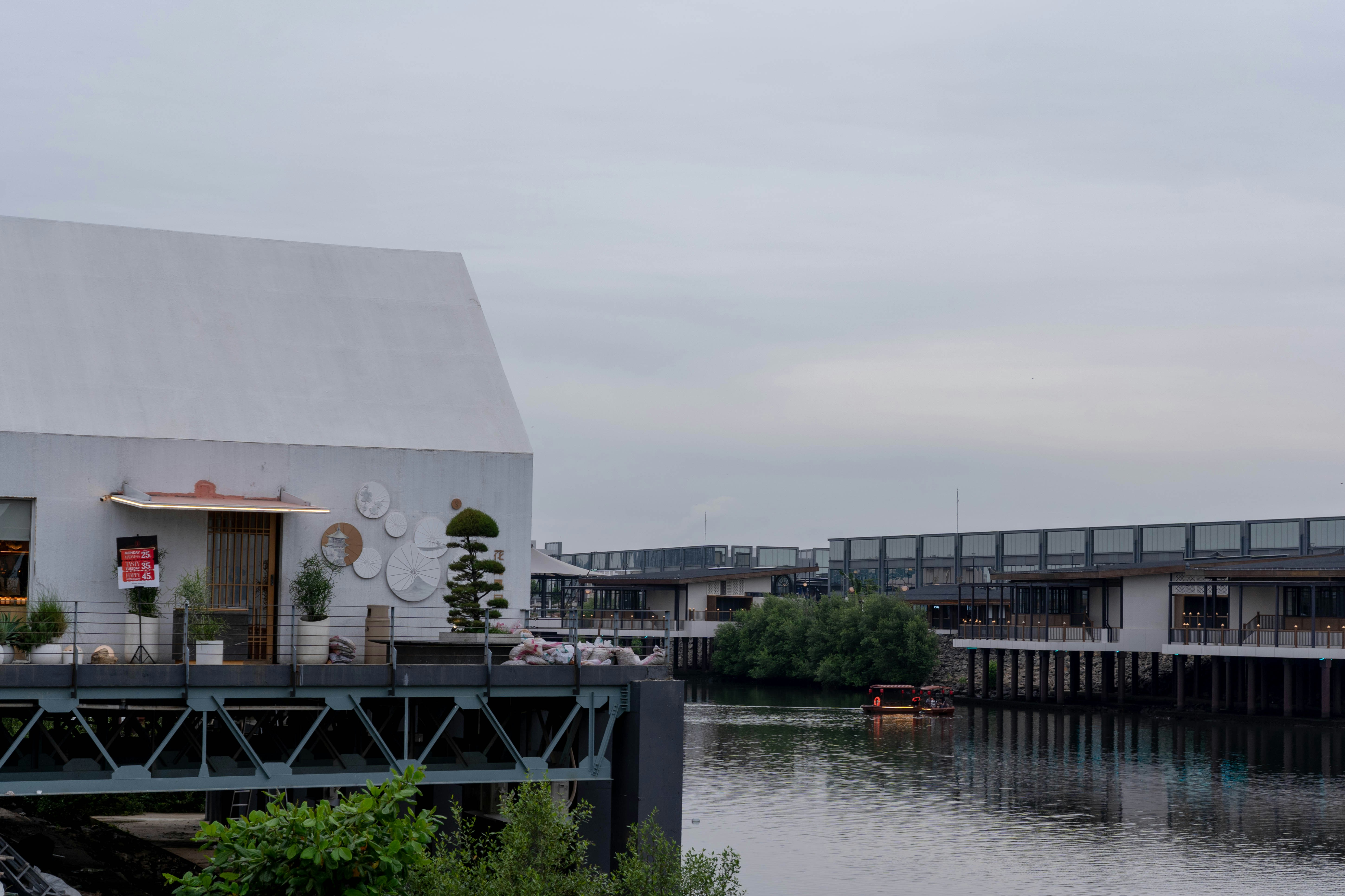 A white building sitting next to a body of water