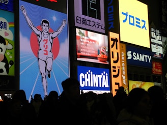 A crowd of people standing in front of a building at night