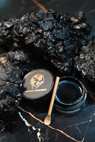 A close up of a jar of black stuff on a table