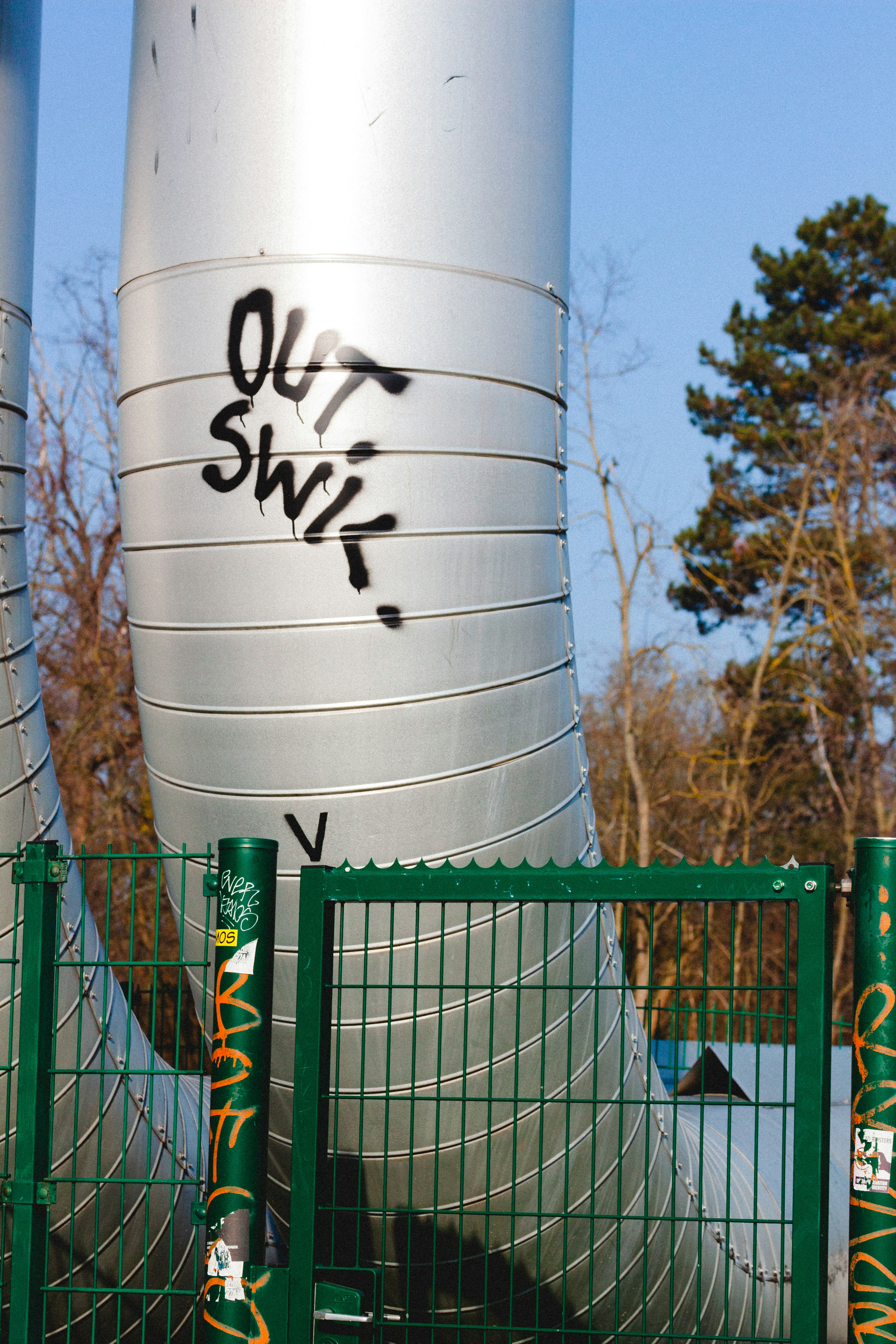A man riding a skateboard on top of a metal fence