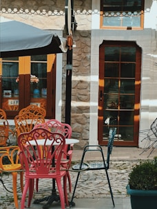 A number of chairs and tables near one another