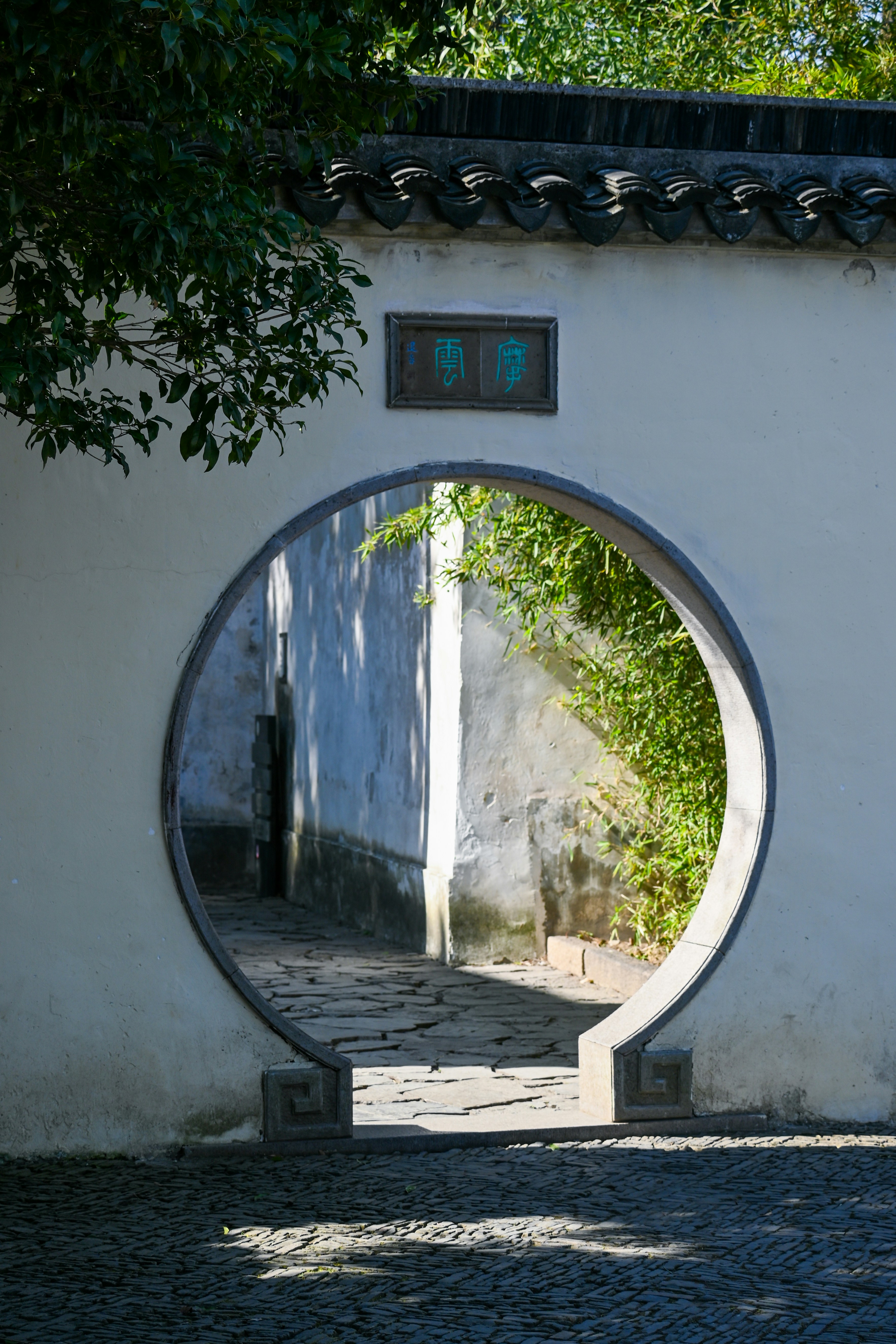 A circular mirror on the side of a building