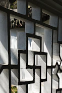 A close up of a metal fence with a clock on it