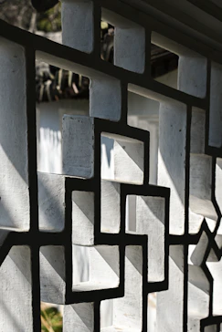 A close up of a metal fence with a clock on it