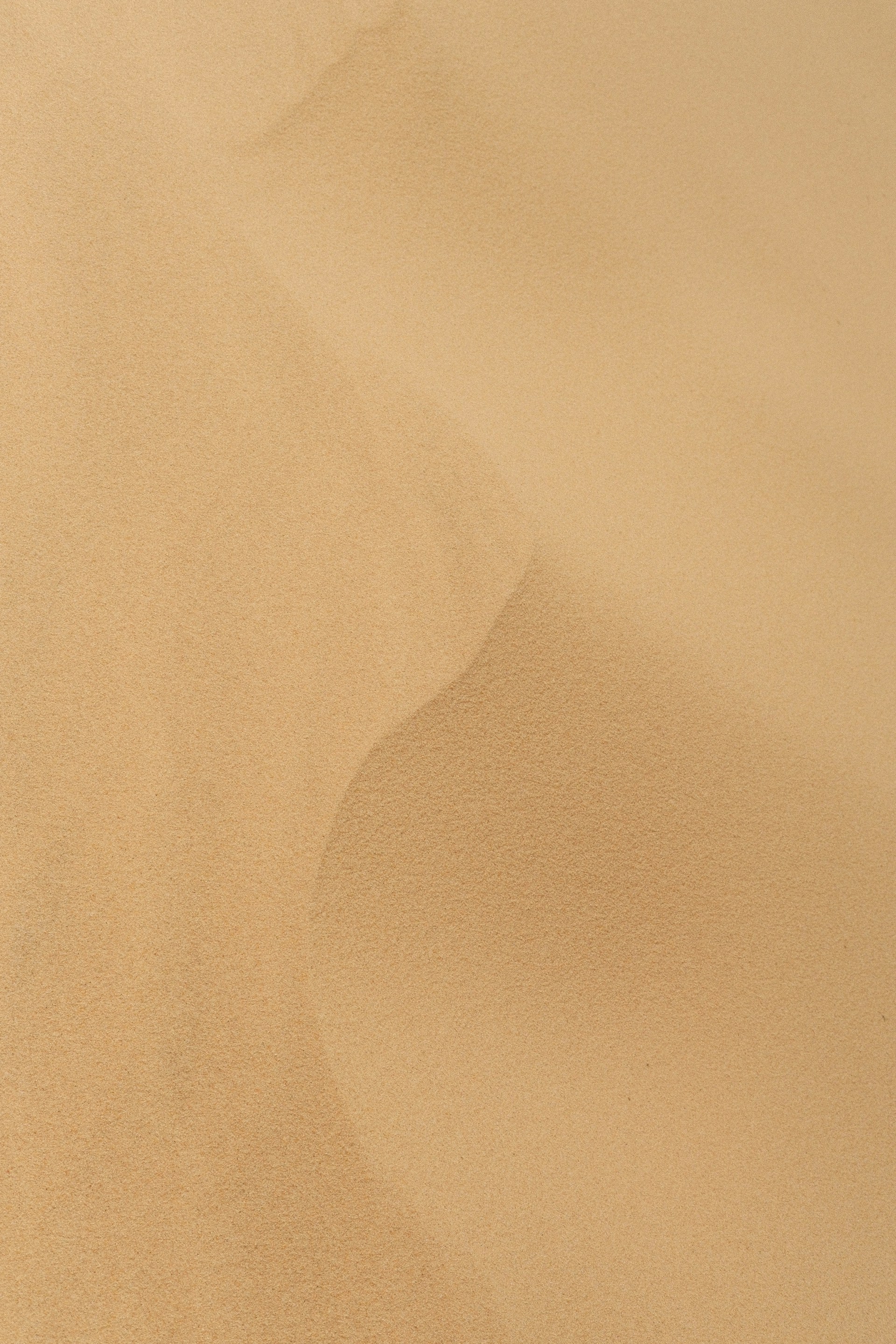 A man riding a snowboard down the side of a snow covered slope