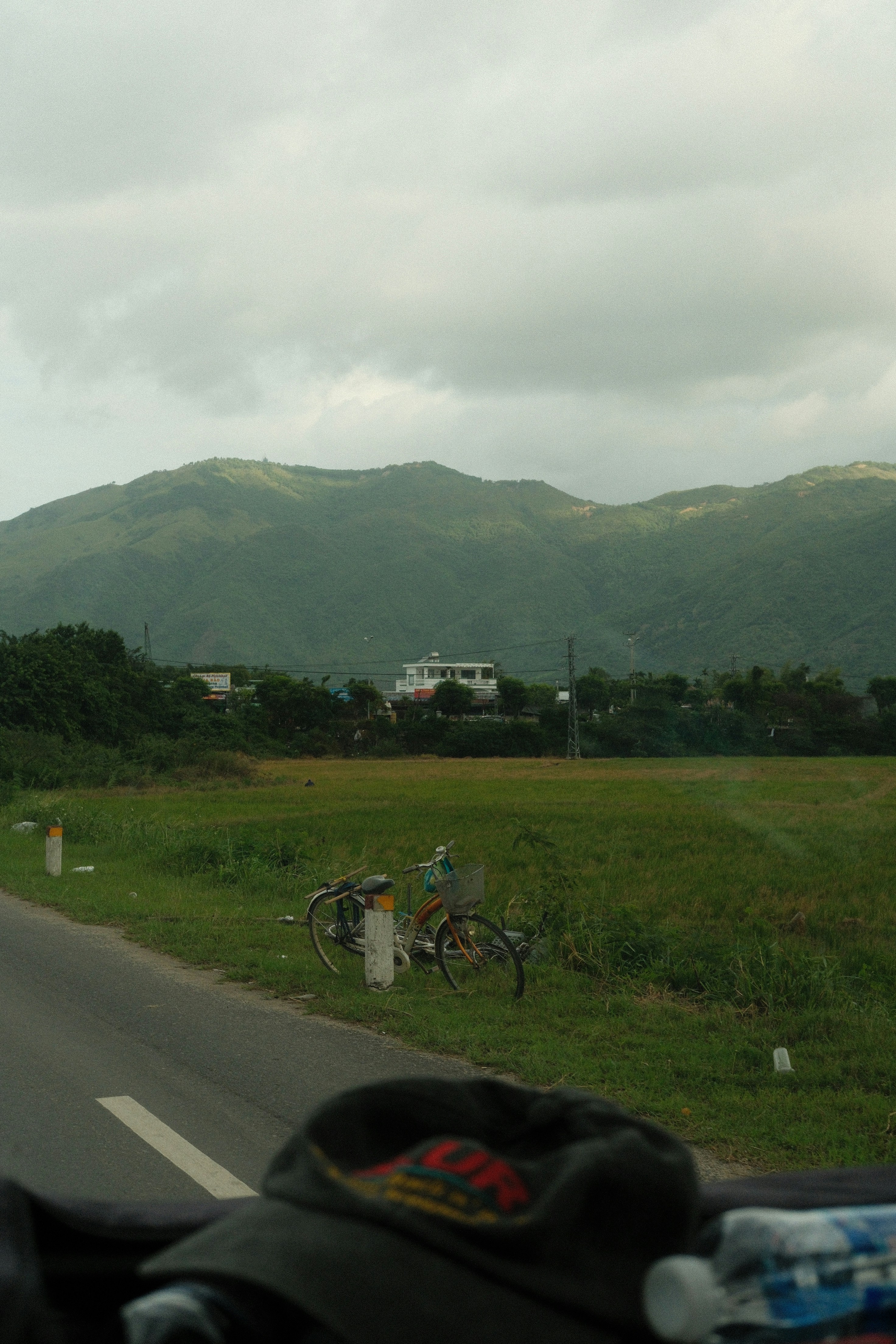 A person riding a motorcycle down a rural road