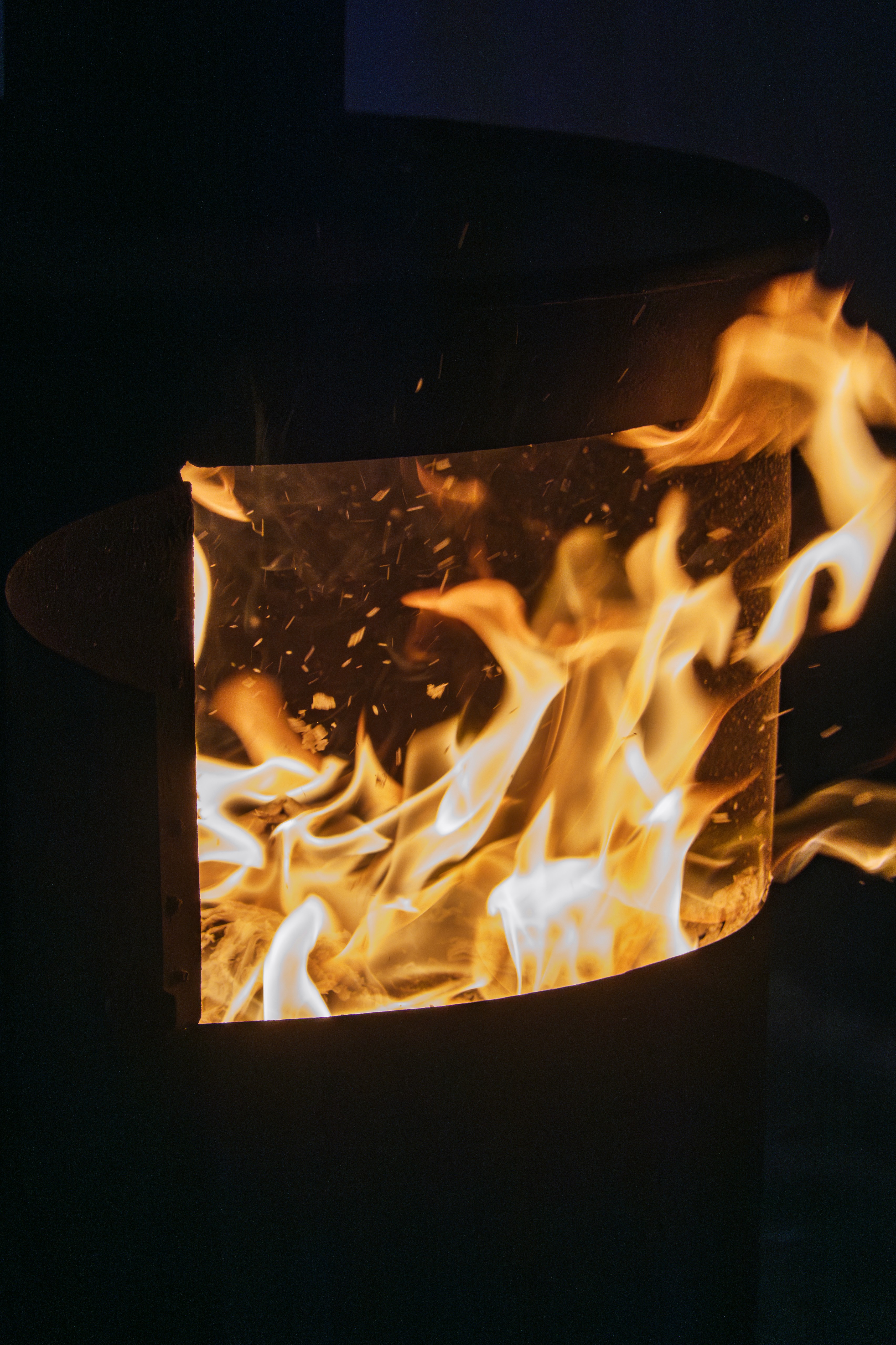 A fire burning inside of a black container