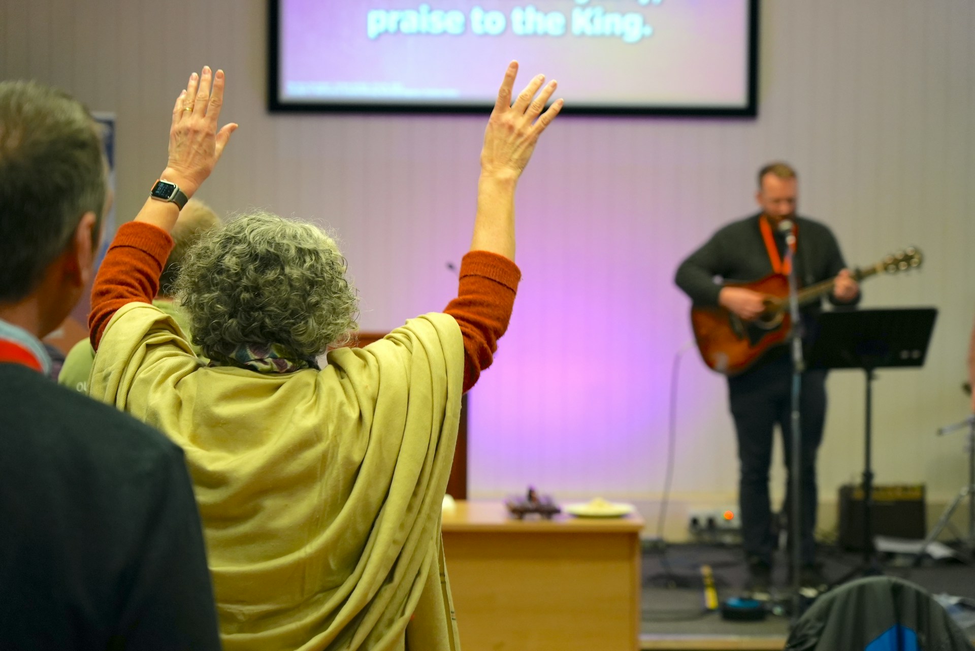 A group of people standing in front of a screen
