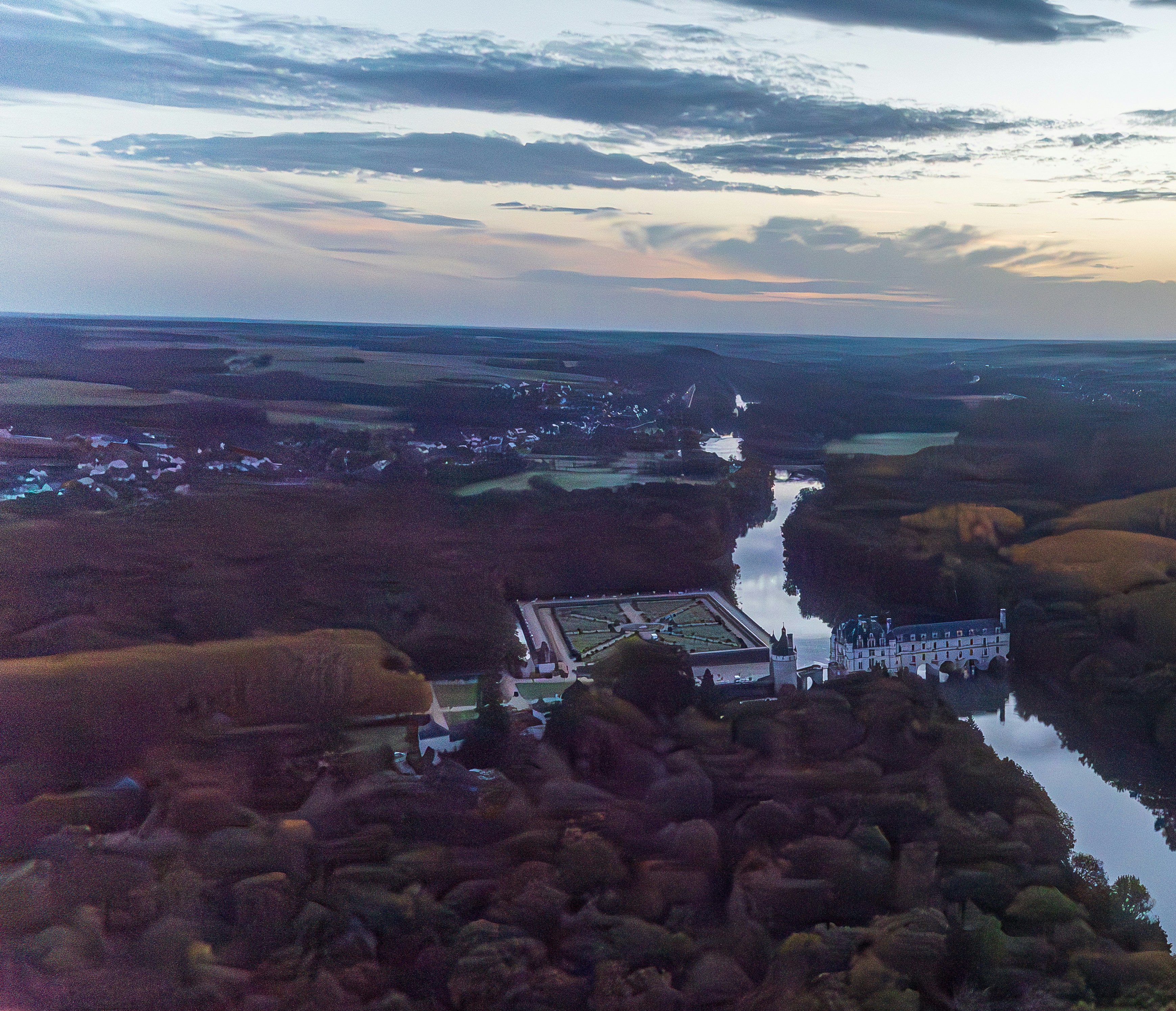 A bird's eye view of a river and a tennis court