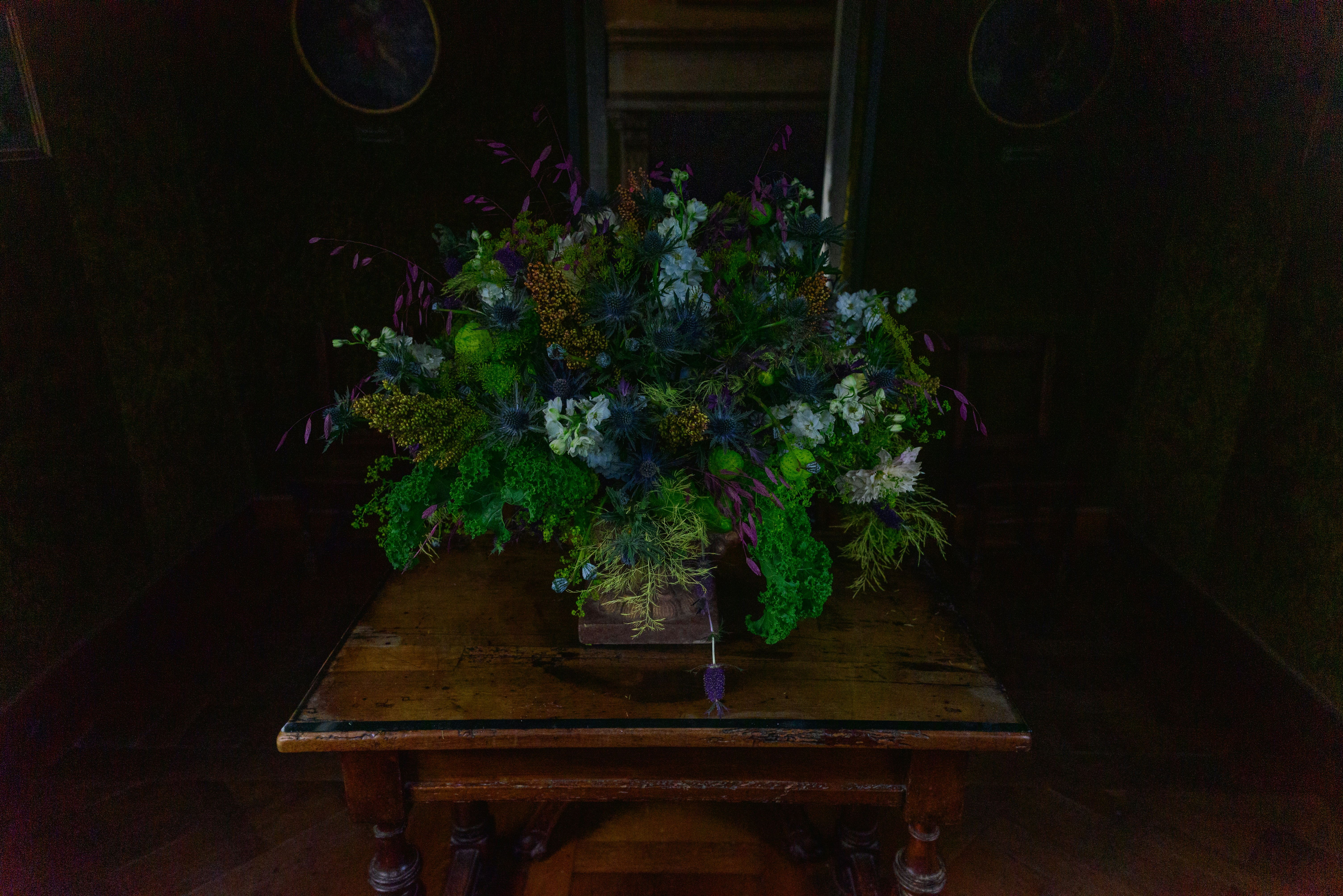 A table with a vase of flowers on top of it