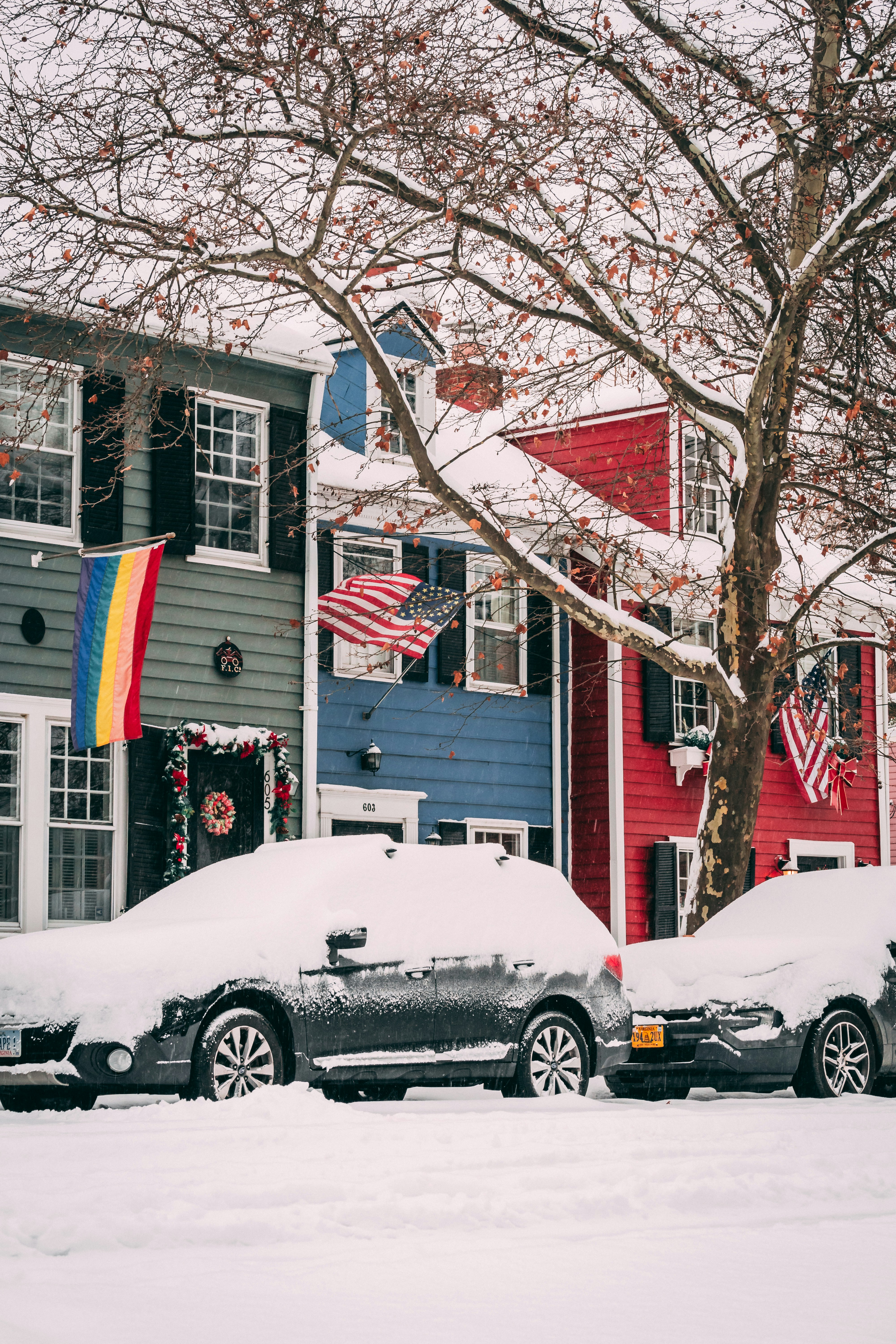 A couple of cars that are covered in snow