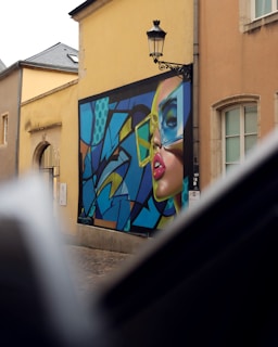 A painting of a woman's face on the side of a building