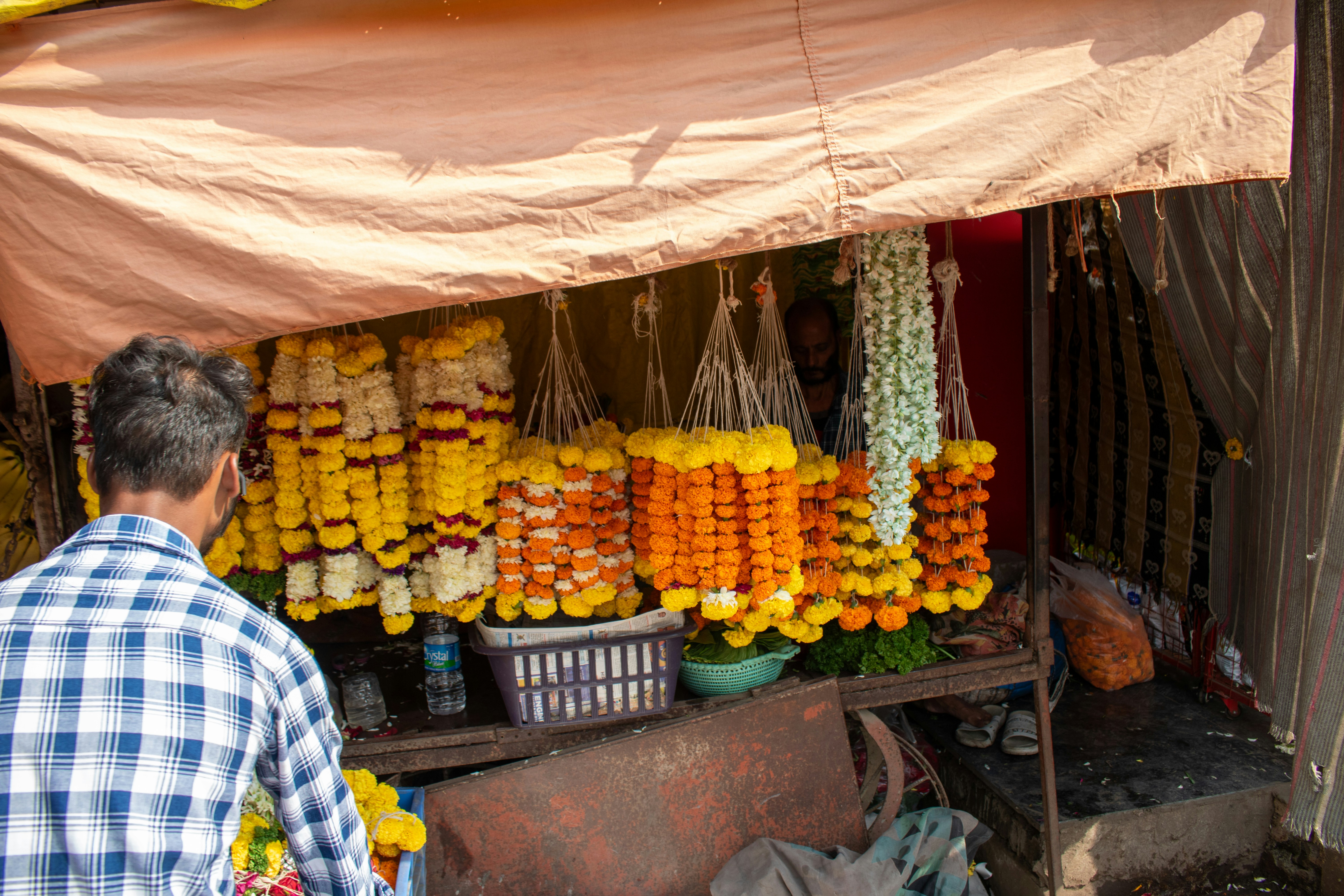 A man standing in front of a fruit stand
